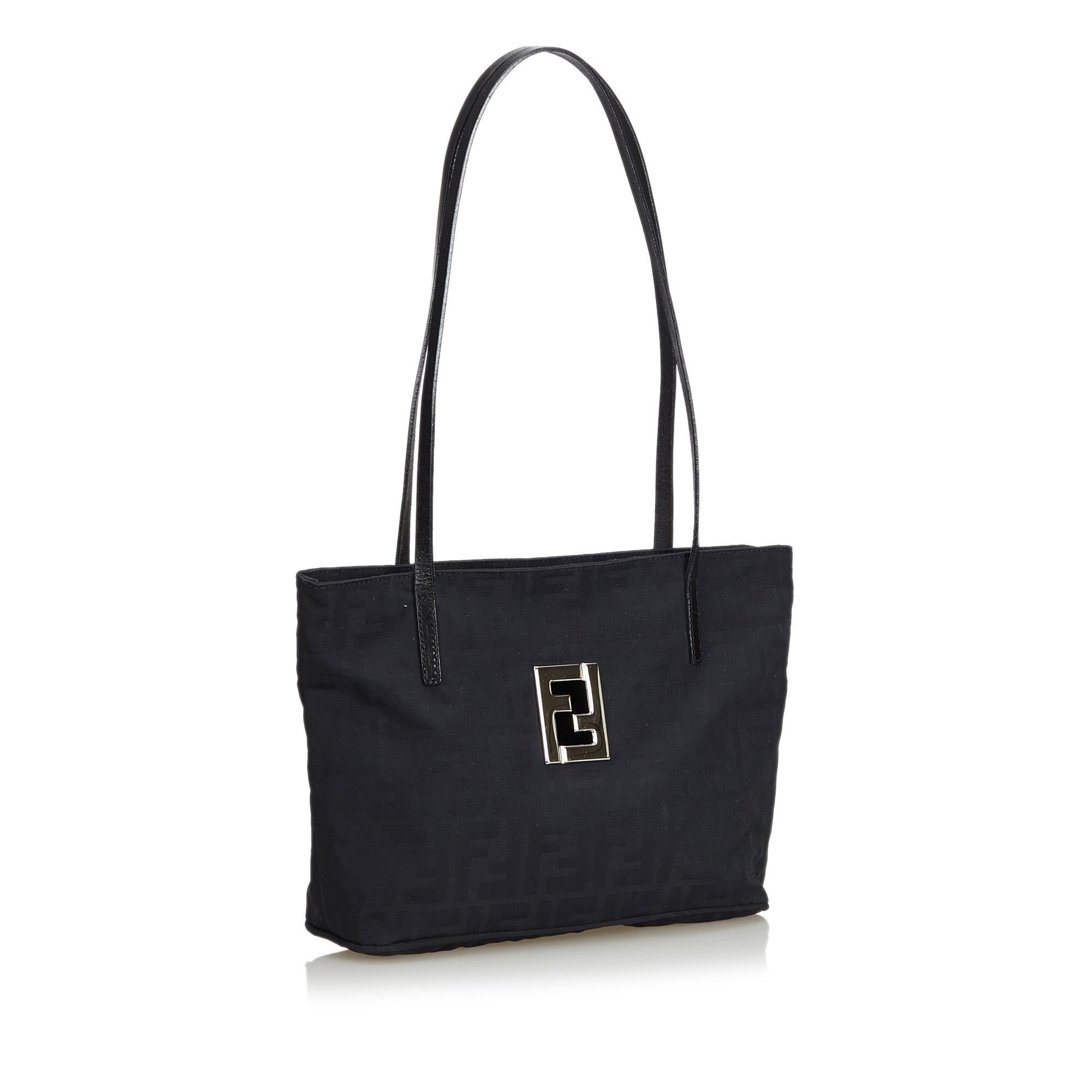 This tote bag features a canvas body, flat leather straps, open top and interior zip compartment and zip pocket. It carries as B+ condition rating.

Inclusions: 
This item does not come with inclusions.

Dimensions:
Length: 20.00 cm
Width: 30.00