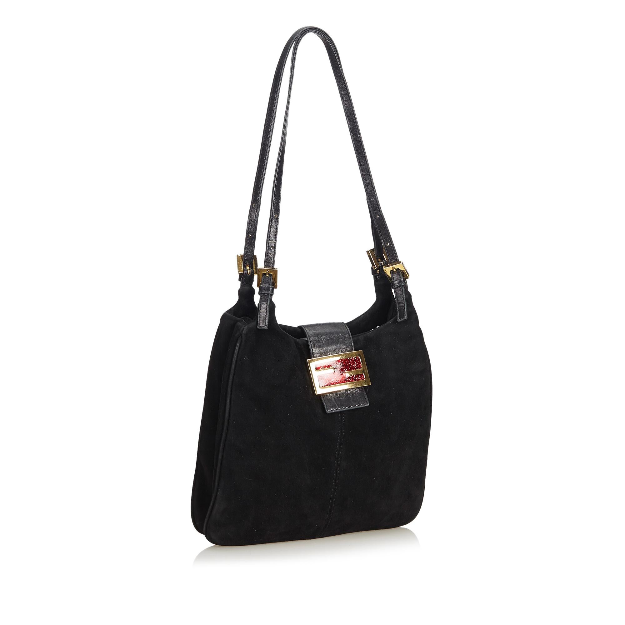 This shoulder bag features a suede body, flat leather straps, open top with flat leather strap and magnetic closure, and an interior zip pocket. It carries as B condition rating.

Inclusions: 
This item does not come with