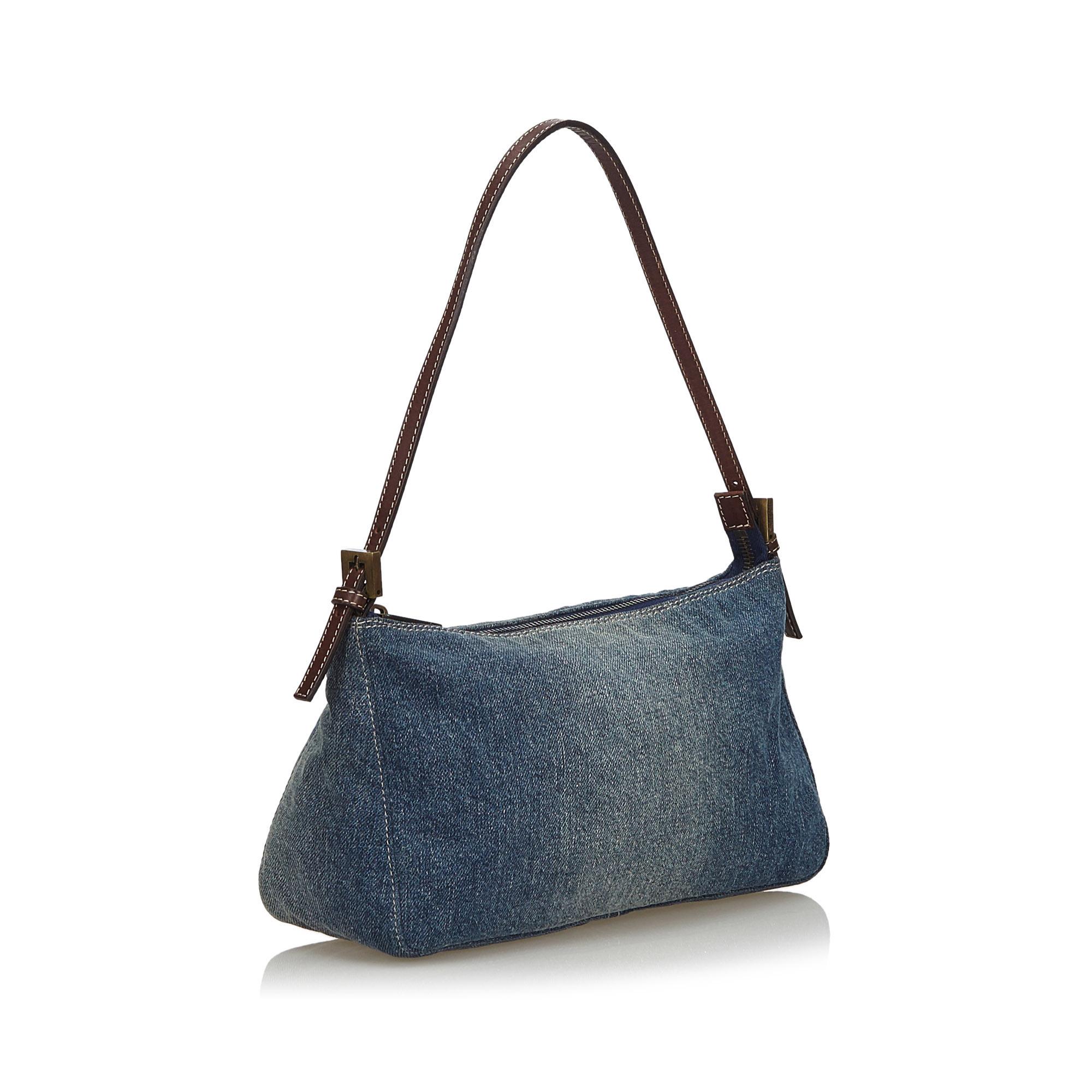 This baguette features a denim body with leather trim, flat leather strap, and top zip closure. It carries as AB condition rating.

Inclusions: 
This item does not come with inclusions.

Dimensions:
Length: 15.00 cm
Width: 25.00 cm
Depth: 9.00
