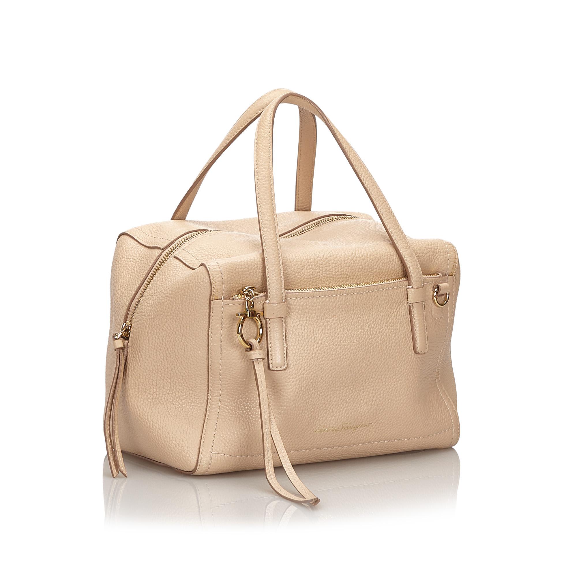 This satchel features a leather body, a front exterior zip pocket, flat leather handles, a detachable flat leather strap, a top zip closure, and interior pockets. It carries as B+ condition rating.

Inclusions: 
This item does not come with