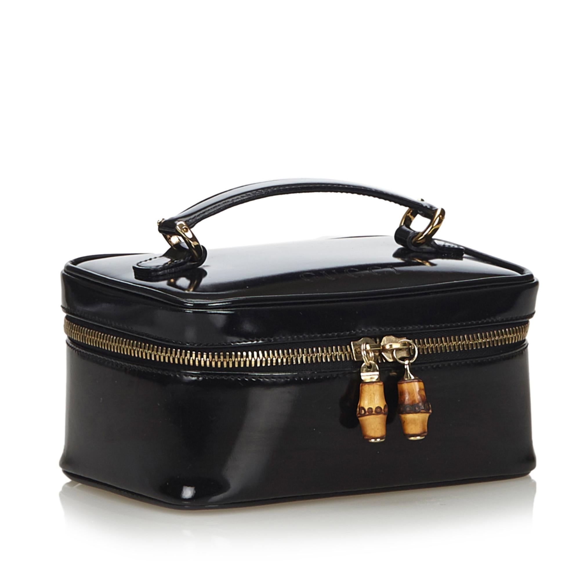 This vanity bag features a patent leather body, a top leather handle, and a zip around closure with bamboo details. It carries as B+ condition rating.

Inclusions: 
Box

Dimensions:
Length: 8.50 cm
Width: 18.00 cm
Depth: 11.00 cm
Hand Drop: 4.00