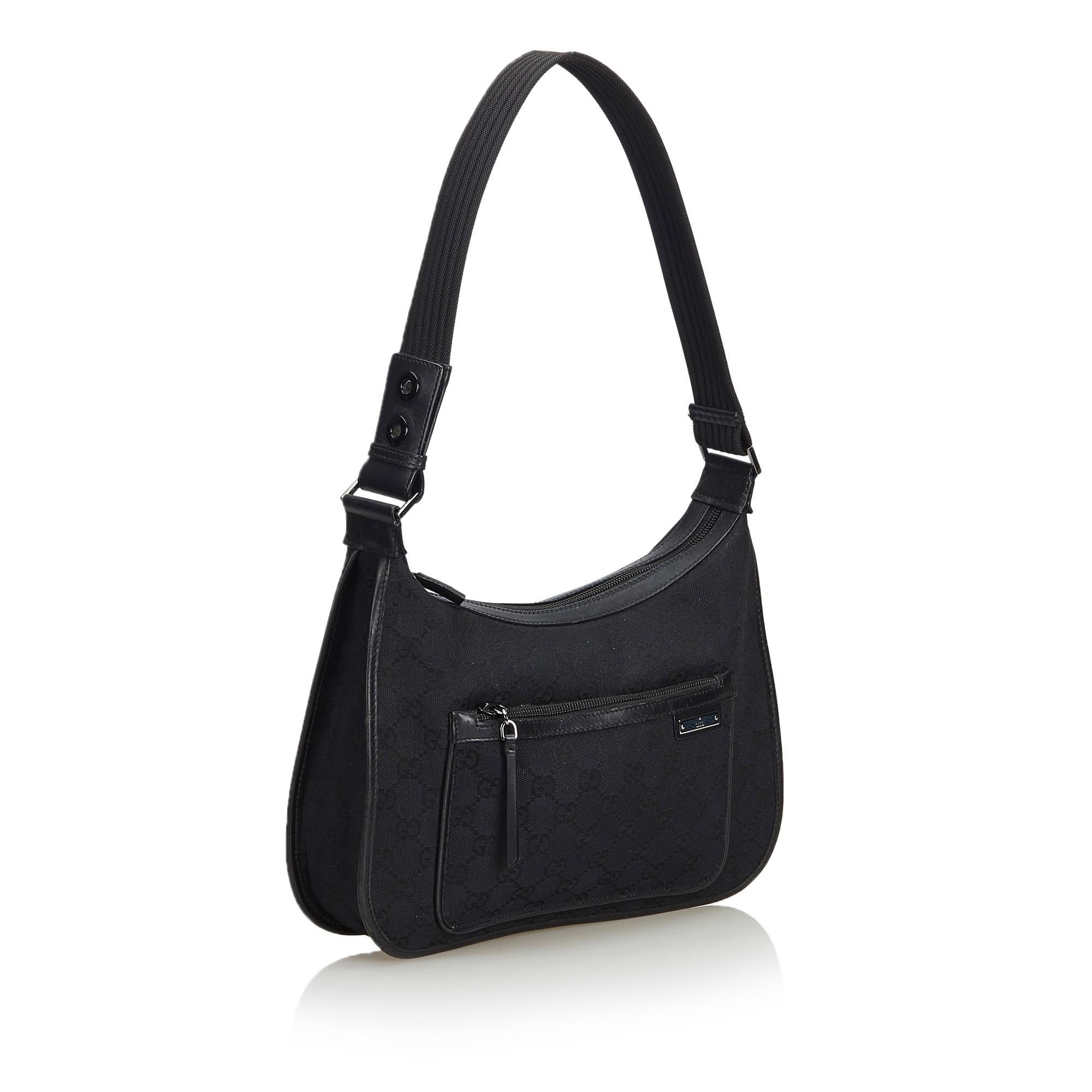 This shoulder bag features a canvas body, an exterior front zip pocket, a flat strap, a top zip closure, and an interior zip pocket. It carries as B condition rating.

Inclusions: 
This item does not come with inclusions.

Dimensions:
Length: 20.00