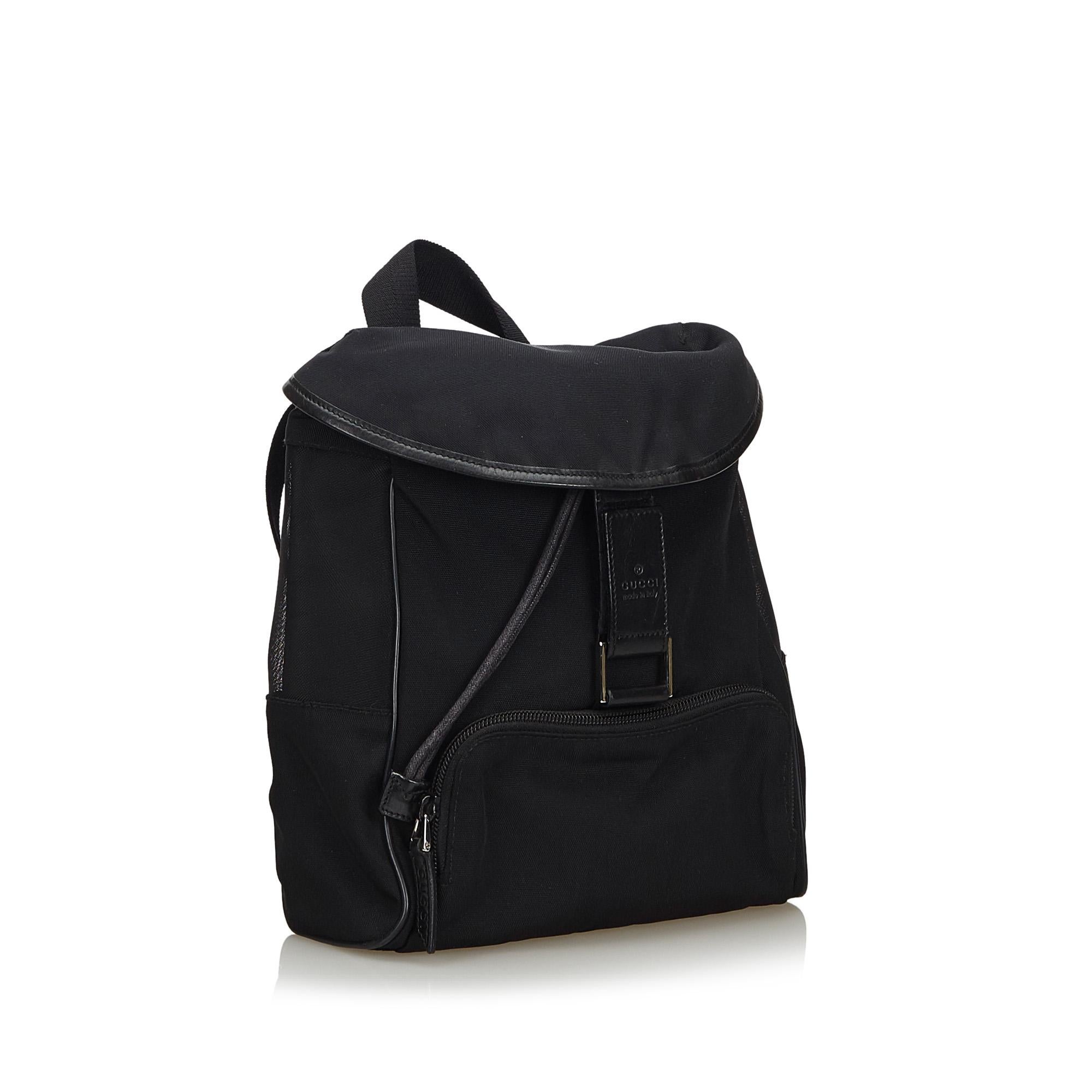 This backpack features a canvas body with mesh panels and leather trim, front exterior zip pocket, flat top handle, flat back straps, top flap with velcro closure, and interior zip pocket. It carries as B+ condition rating.

Inclusions: 
This item
