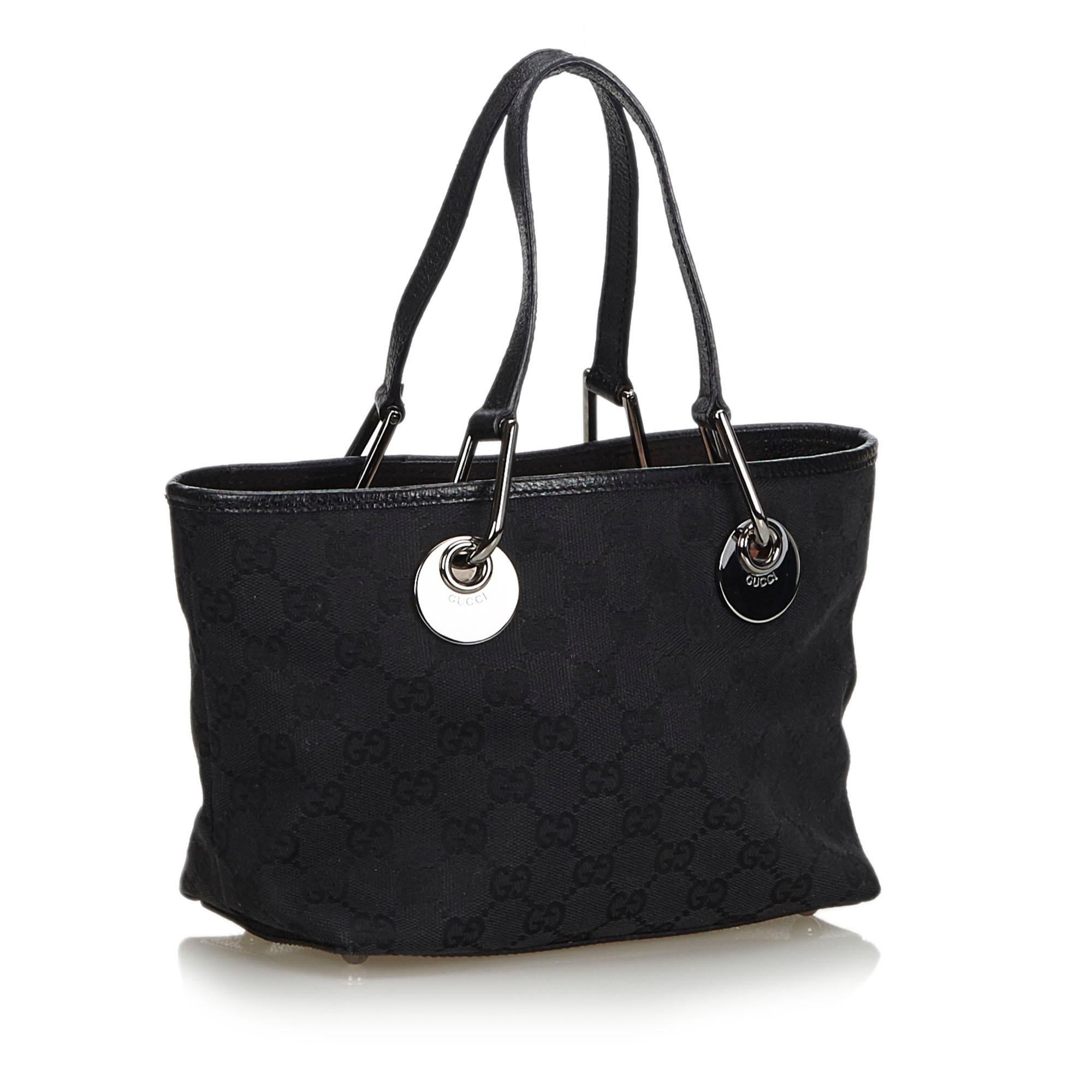 The Eclipse tote bag features a canvas body with leather trim, flat leather straps with a silver-tone hardware, an open top, and interior zip and slip pockets. It carries as AB condition rating.

Inclusions: 
Dust Bag

Dimensions:
Length: 16.00