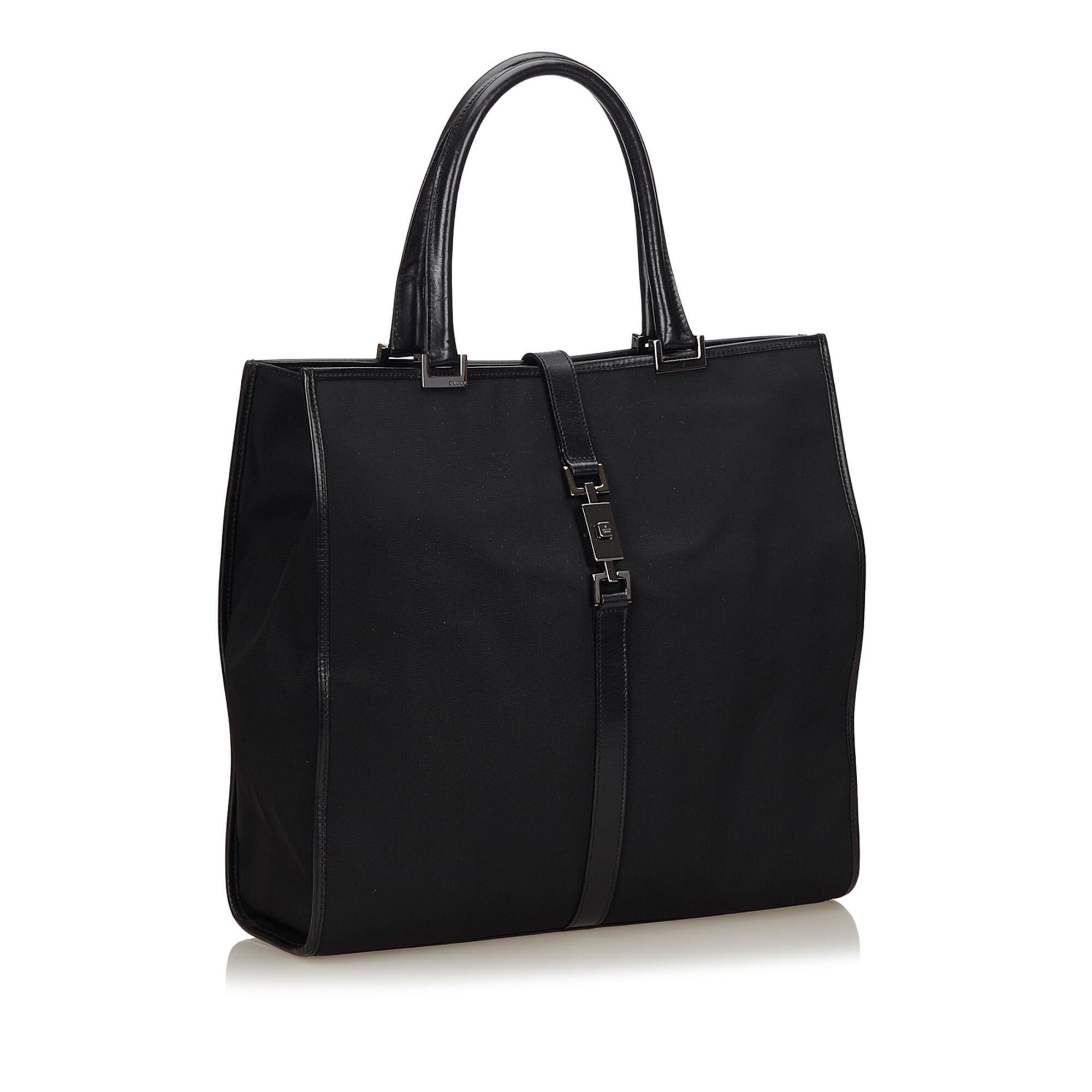 This tote bag features a nylon body with leather trim, rolled leather handles, open top with Jackie strap and interior zip pocket. It carries as A condition rating.

Inclusions: 
Dust Bag

Dimensions:
Length: 33.00 cm
Width: 31.00 cm
Depth: 7.00