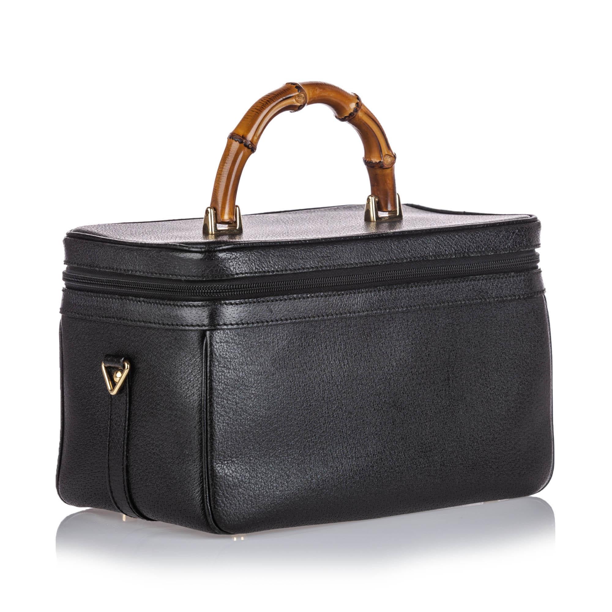 This vanity bag features a leather body, a bamboo top handle, a flat leather strap, a zip around closure, an interior mirror and a zip pocket. It carries as AB condition rating.

Inclusions: 
This item does not come with