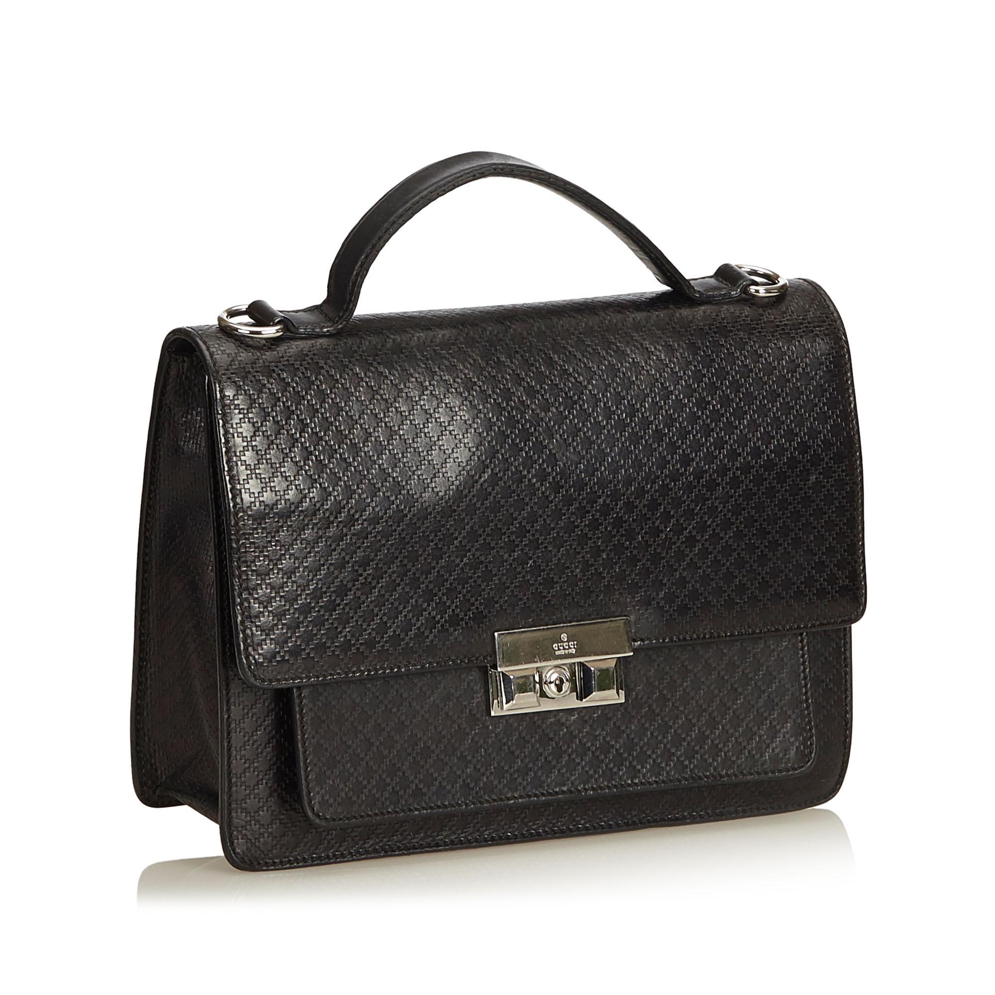 This business bag features a leather body, flat leather handle, detachable shoulder strap, front flap with push lock closure, exterior zip and slip pockets, and an interior zip pocket. It carries as B+ condition rating.

Inclusions: 
This item does