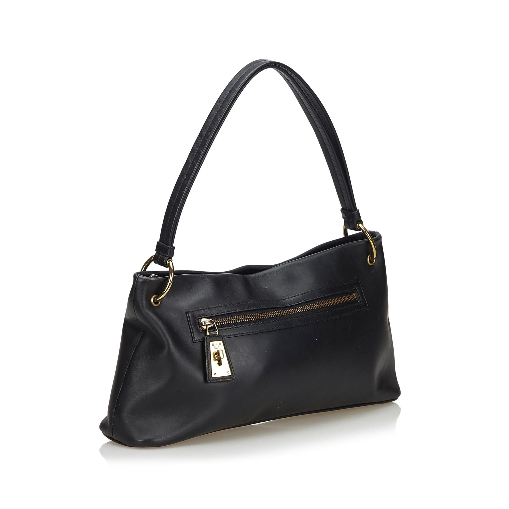 This shoulder bag features a leather body, rolled leather handles, a top zip closure, exterior zip pocket, and an interior zip pocket. It carries as B+ condition rating.

Inclusions: 
This item does not come with inclusions.

Dimensions:
Length: