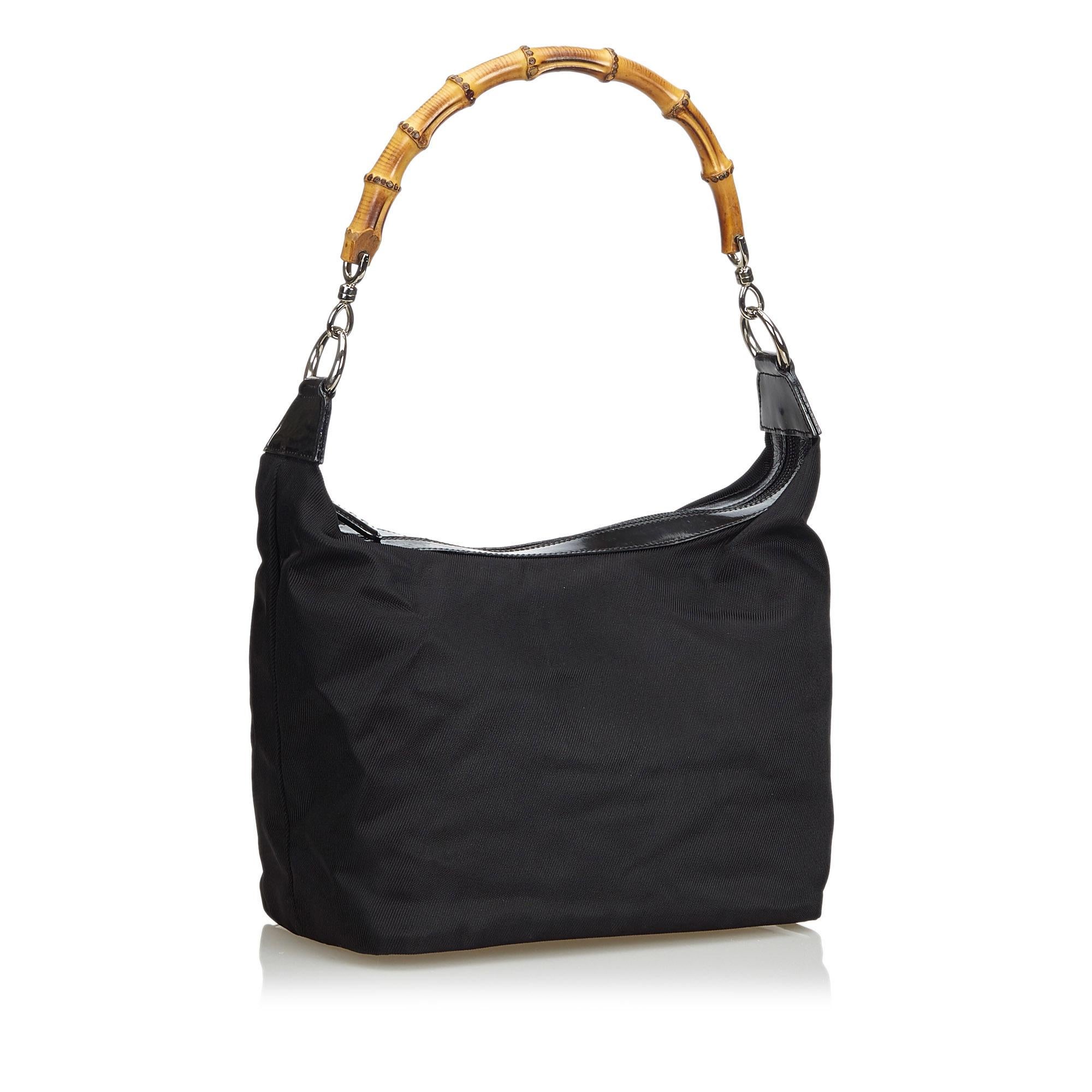 This handbag features a nylon body with leather trim, a bamboo handle, a top zip closure and an interior zip pocket. It carries as B+ condition rating.

Inclusions: 
This item does not come with inclusions.

Dimensions:
Length: 19.00 cm
Width: 36.00