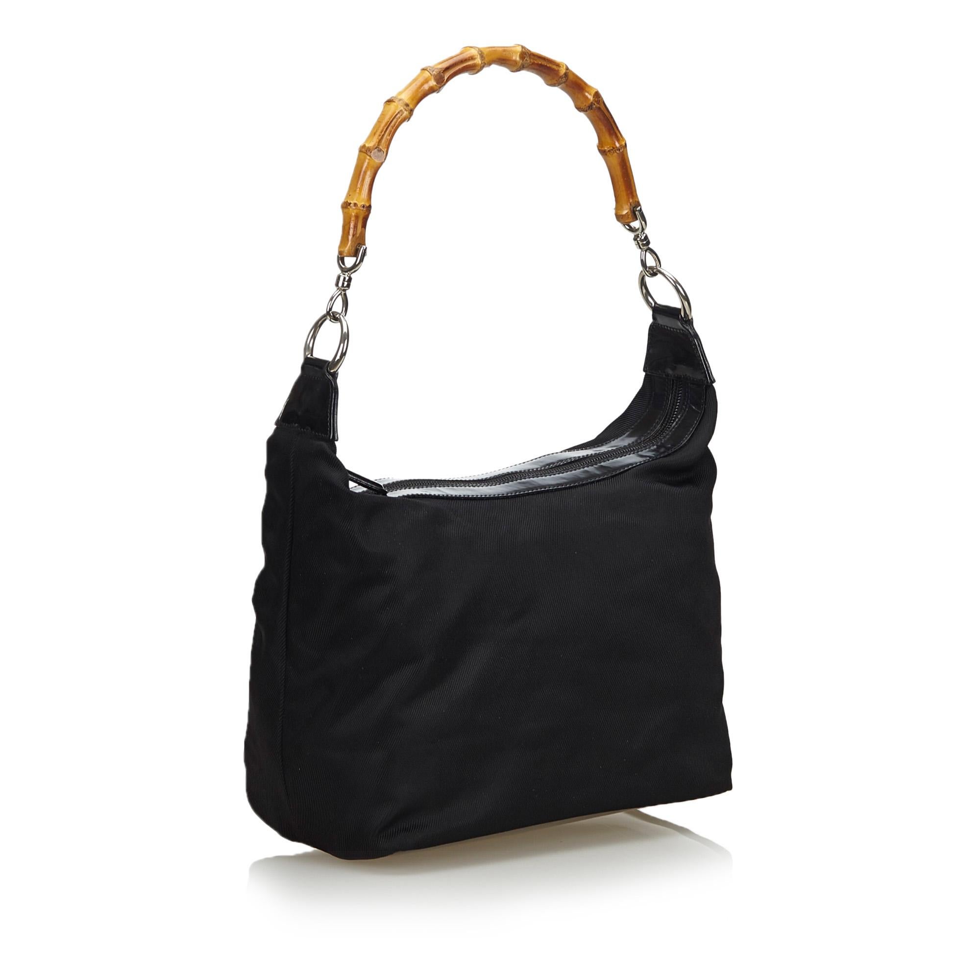 This shoulder bag features a nylon body, bamboo top handles, a top zip closure, and an interior zip pocket. It carries as B+ condition rating.

Inclusions: 
This item does not come with inclusions.

Dimensions:
Length: 18.00 cm
Width: 33.00