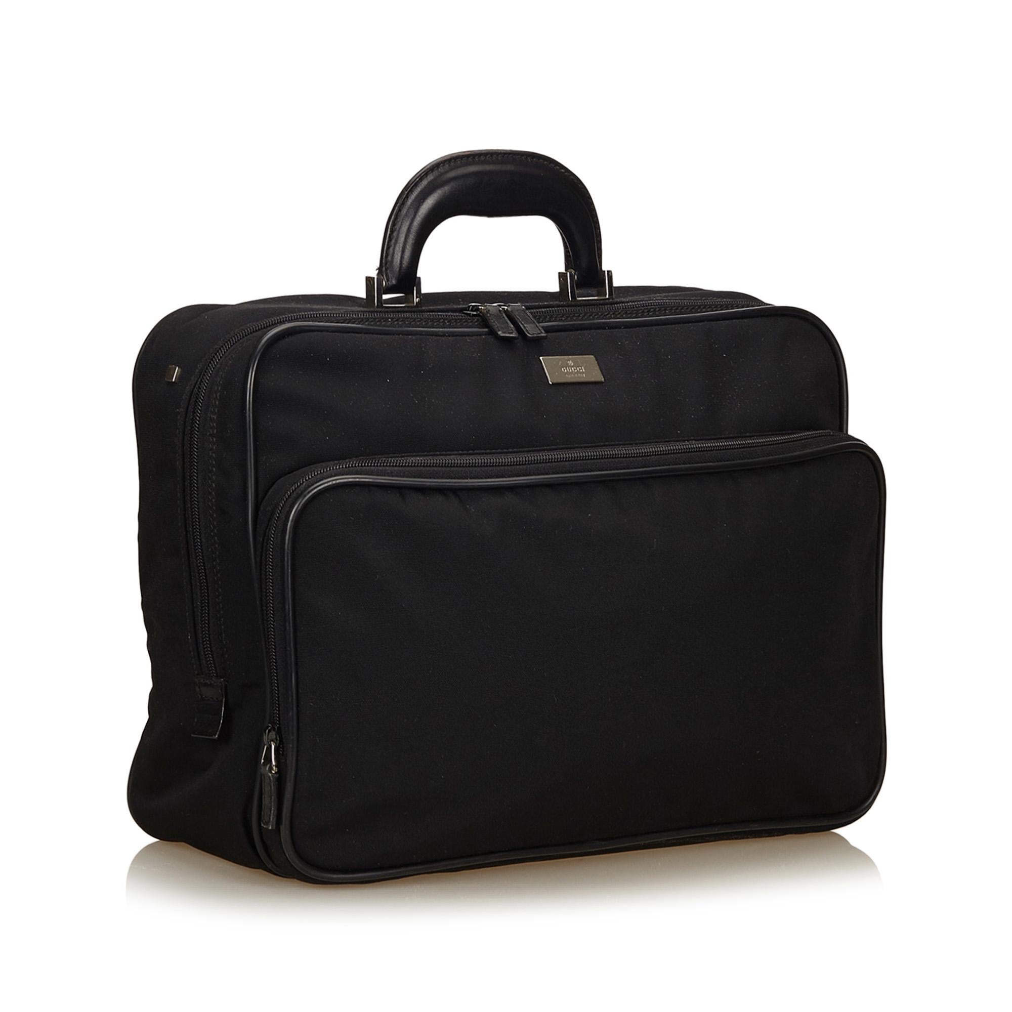 This briefcase features a nylon body, exterior front zip pocket, structured leather handle, zip around closure, and interior zip pocket. It carries as B+ condition rating.

Inclusions: 
Dust Bag

Dimensions:
Length: 40.00 cm
Width: 30.00 cm
Depth: