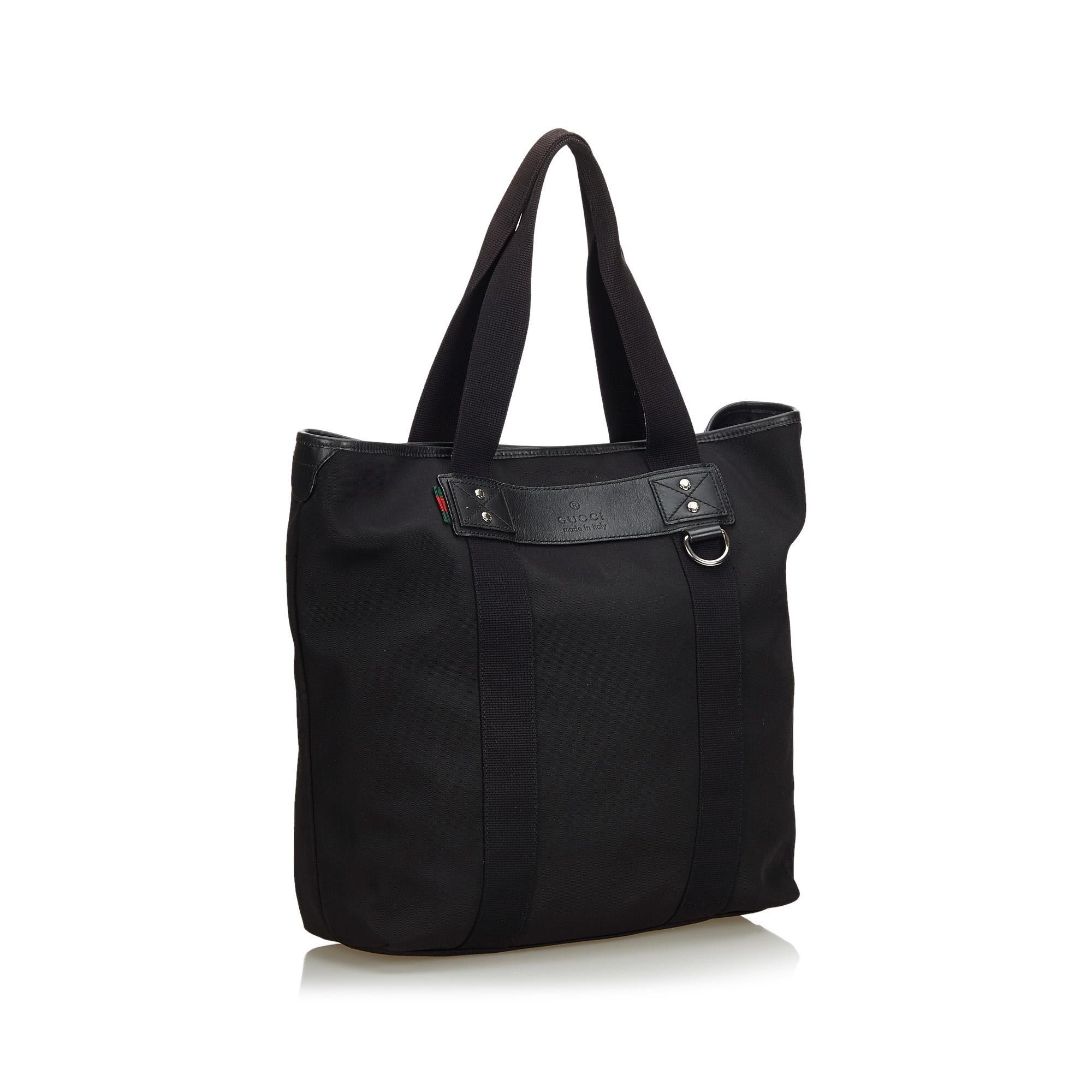 This tote bag features a nylon body with leather trim, flat straps, an open top, and interior zip and slip pockets. It carries as AB condition rating.

Inclusions: 
This item does not come with inclusions.

Dimensions:
Length: 38.00 cm
Width: 41.50