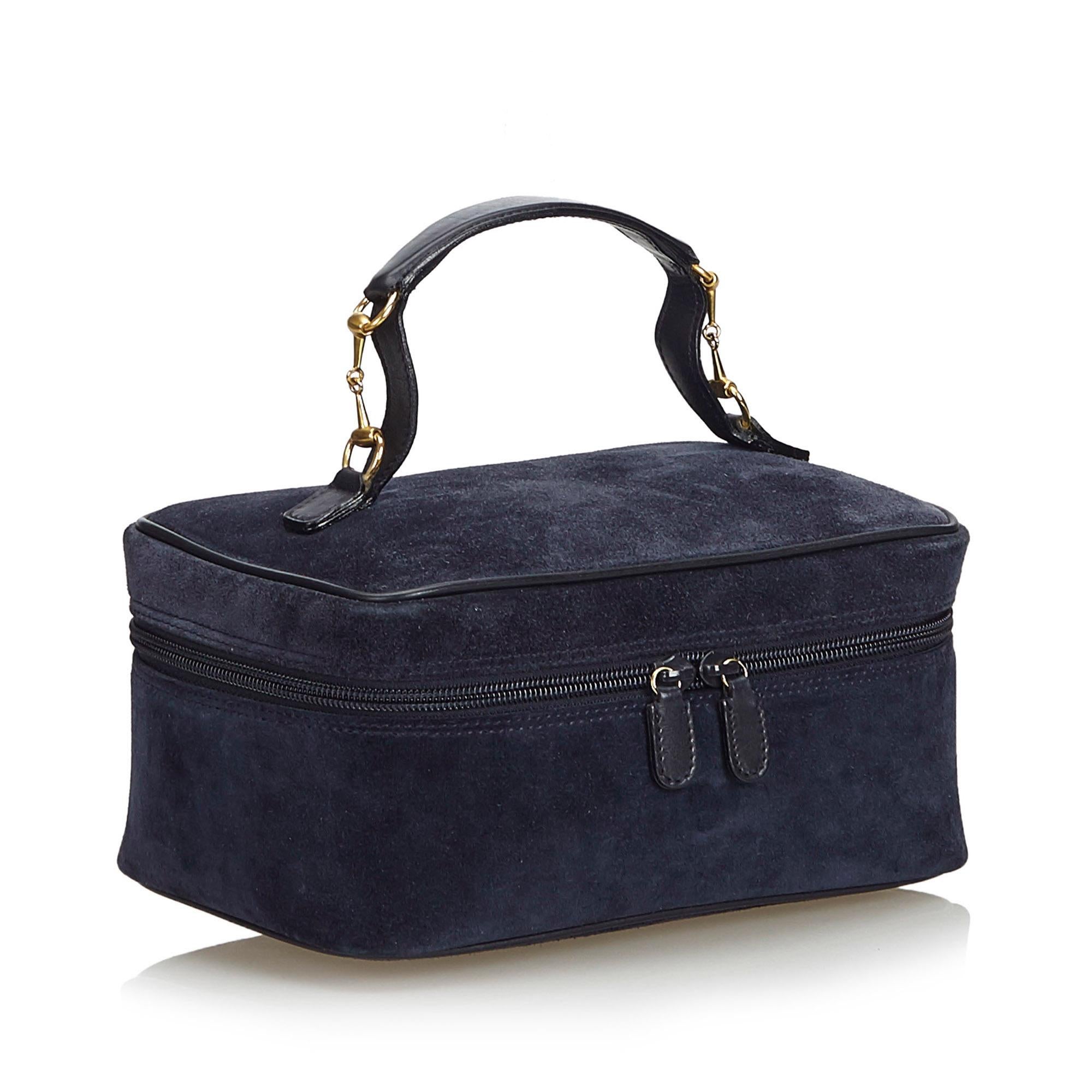 This vanity bag features a suede body with leather trim, a leather top handle with gold-tone horse bit hardware, and a top zip around closure. It carries as B+ condition rating.

Inclusions: 
This item does not come with