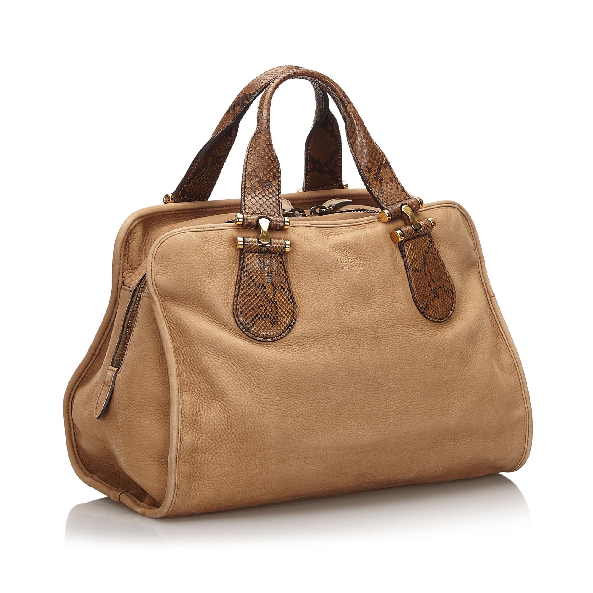 This boston bag features a nubuck leather body, flat python handles, a top zip closure, and interior zip and slip pockets. It carries as B+ condition rating.

Inclusions: 
This item does not come with inclusions.

Dimensions:
Length: 25.00 cm
Width: