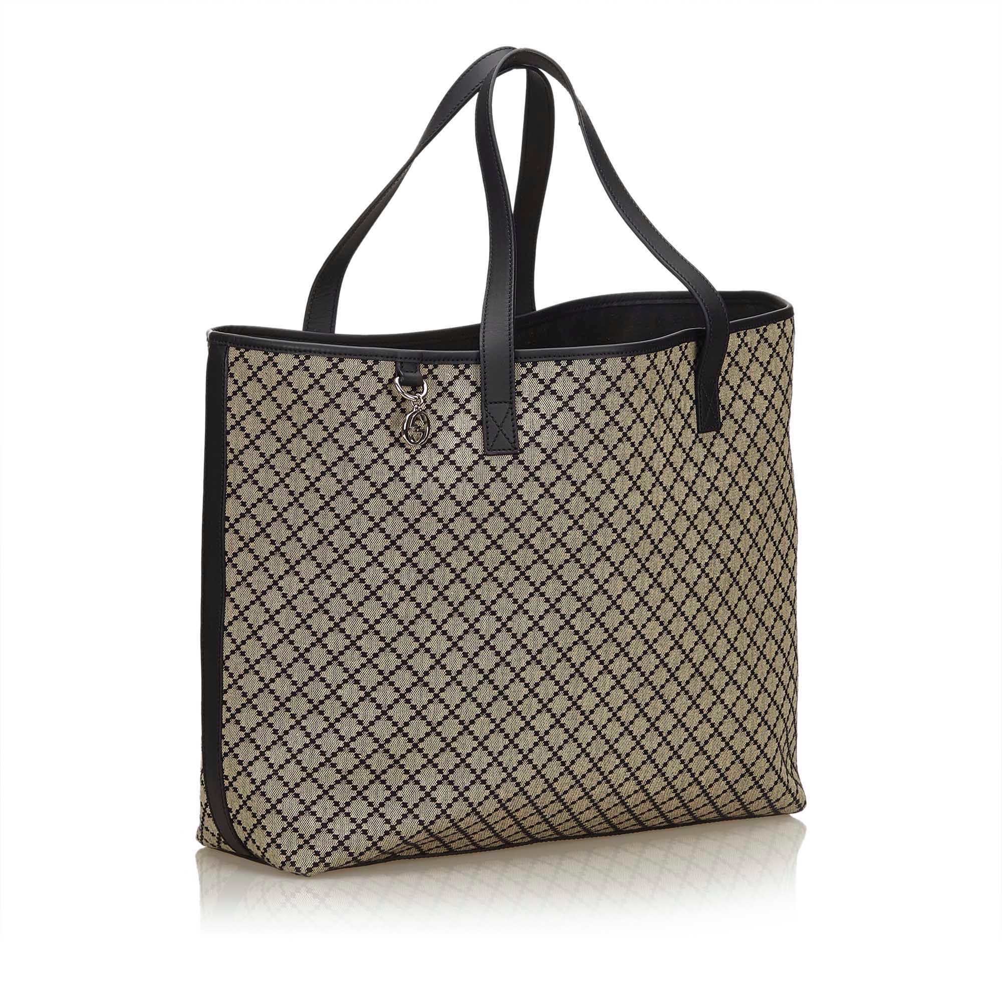 This tote bag features a jacquard body, flat leather straps open top, and an interior zip pocket. It carries as A condition rating.

Inclusions: 
This item does not come with inclusions.

Dimensions:
Length: 33.00 cm
Width: 37.00 cm
Depth: 12.00