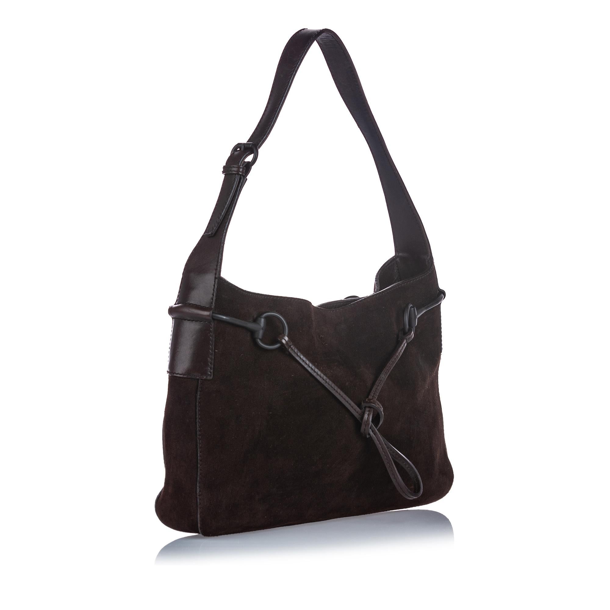 This shoulder bag features a suede body, a flat leather strap, an open top with a magnetic closure, and an interior zip pocket. It carries as B+ condition rating.

Inclusions: 
This item does not come with inclusions.

Dimensions:
Length: 24.00