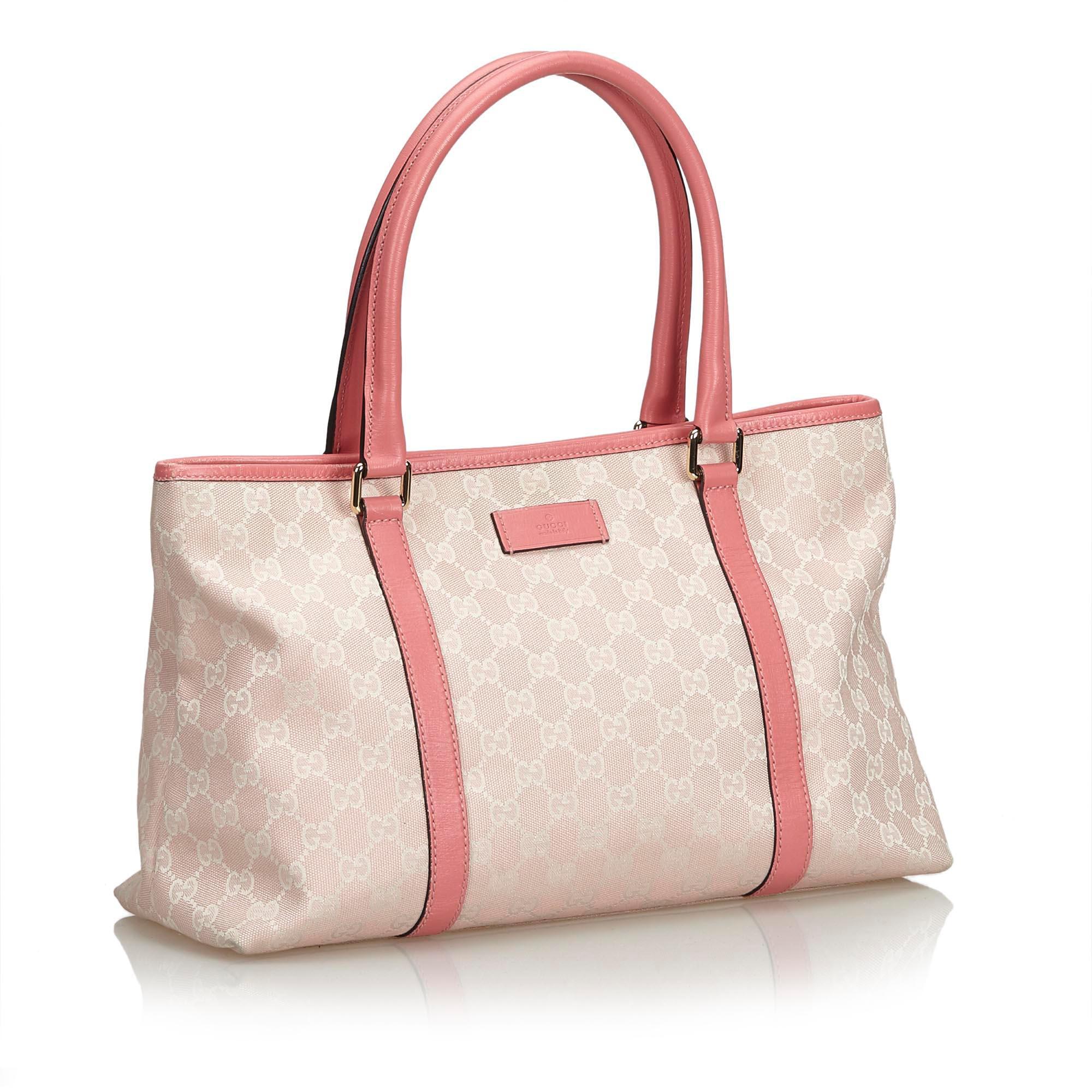 This tote bag features a jacquard body with leather trim, a flat leather strap, an open top with a magnetic closure, and interior zip and slip pockets. It carries as B+ condition rating.

Inclusions: 
This item does not come with