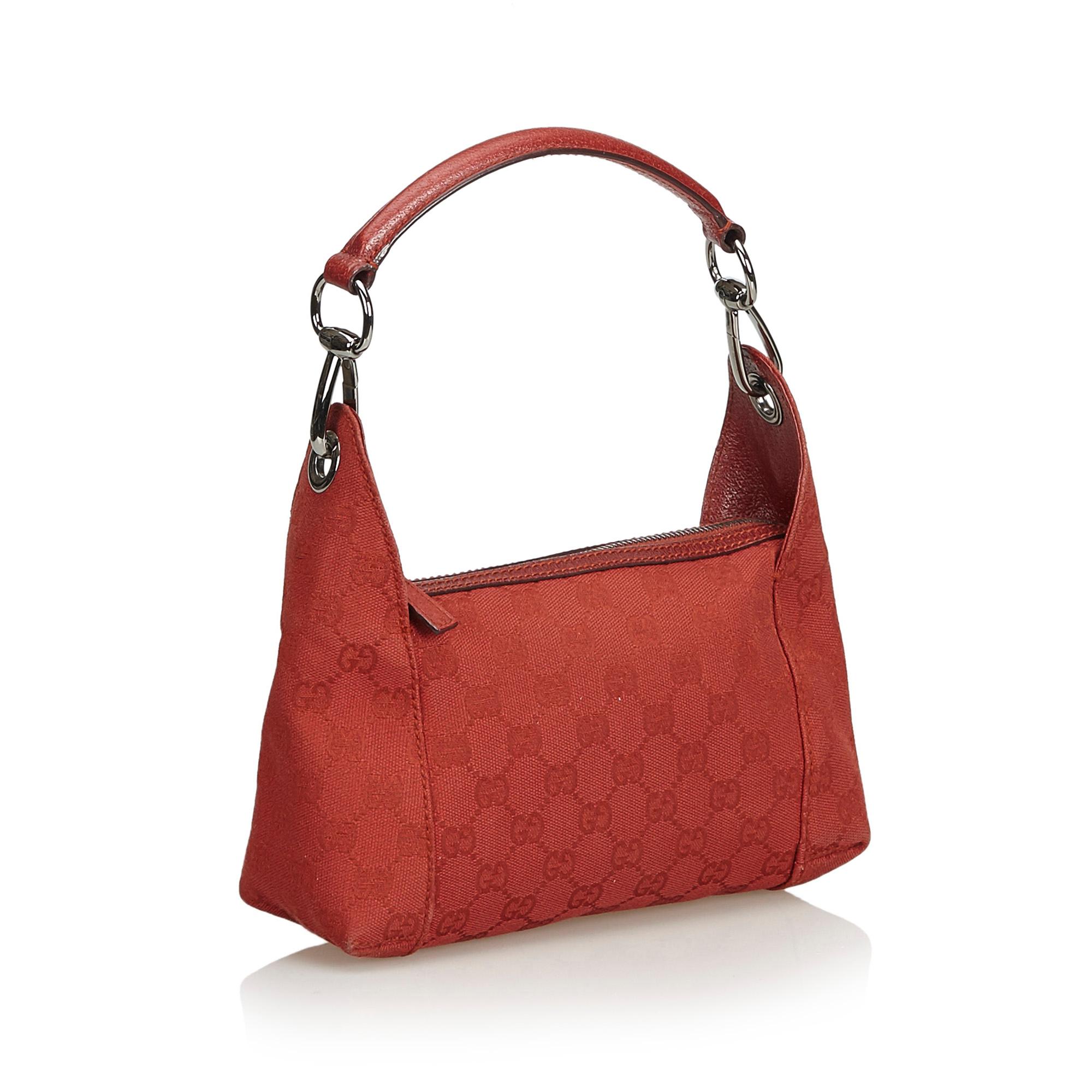This shoulder bag features a jacquard body with leather trim, flat leather handle, top zip closure, and interior zip pocket. It carries as B+ condition rating.

Inclusions: 
Dust Bag

Dimensions:
Length: 15.00 cm
Width: 23.00 cm
Depth: 6.00 cm
Hand