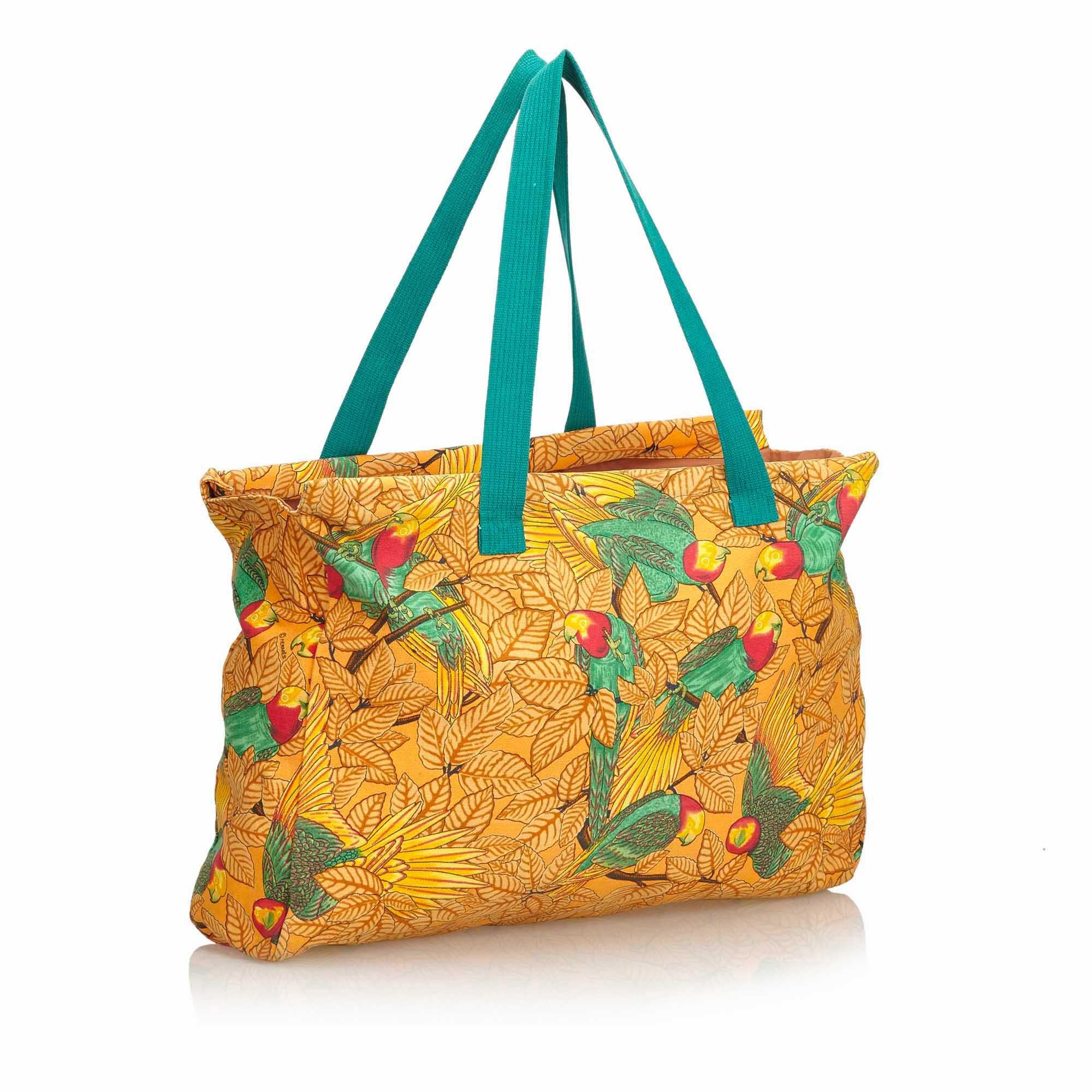 This tote bag features a printed canvas body, flat handles, and an open top. It carries as AB condition rating.

Inclusions: 
This item does not come with inclusions.

Dimensions:
Length: 34.00 cm
Width: 46.00 cm
Depth: 9.00 cm
Hand Drop: 25.00