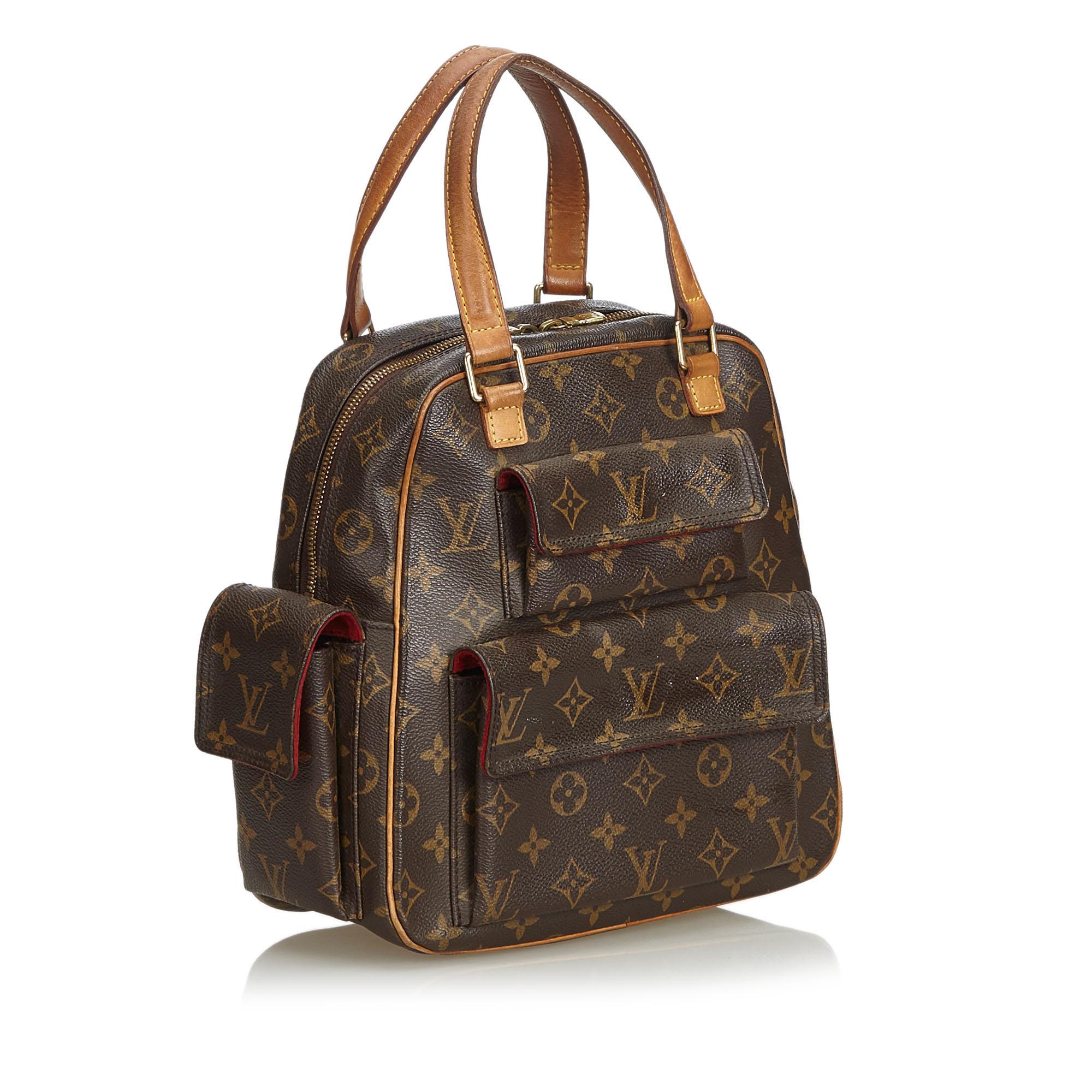 The Excentri-Cite features the Monogram canvas, flat vachetta straps and trim, exterior flap pockets, a two-way top zip closure, and interior pockets. It carries as B condition rating.

Inclusions: 
Dust Bag

Louis Vuitton pieces do not come with an