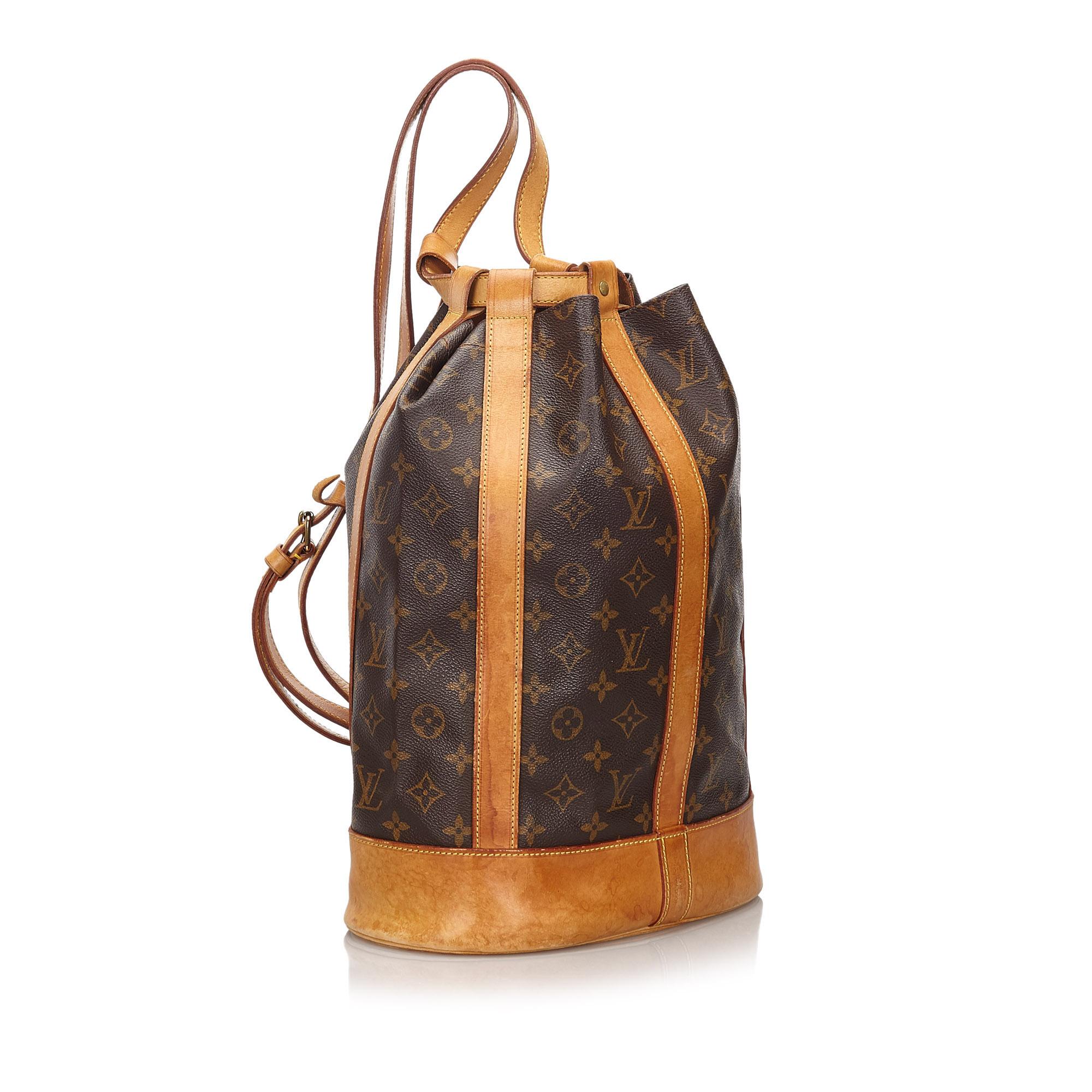 The Randonnee features a monogram canvas body with leather trim, a flat leather strap, a top drawstring closure, and an interior zip pocket. It carries as B condition rating.

Inclusions: 
This item does not come with inclusions.


Louis Vuitton