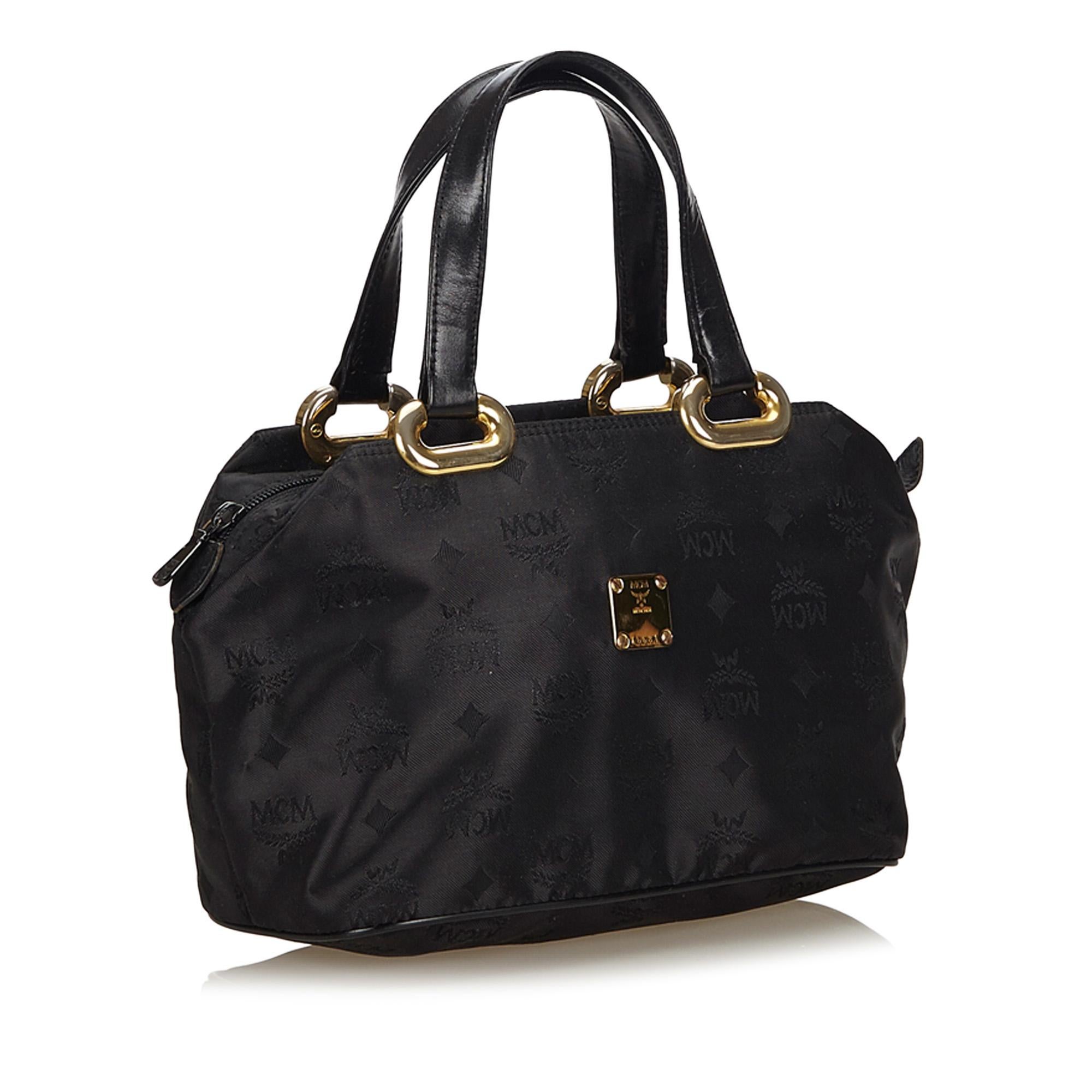 This handbag features a nylon body, gold-tone hardware, a top zip closure, and an interior zip pocket. It carries as B condition rating.

Inclusions: 
This item does not come with inclusions.

Dimensions:
Length: 34.00 cm
Width: 17.50 cm
Depth: