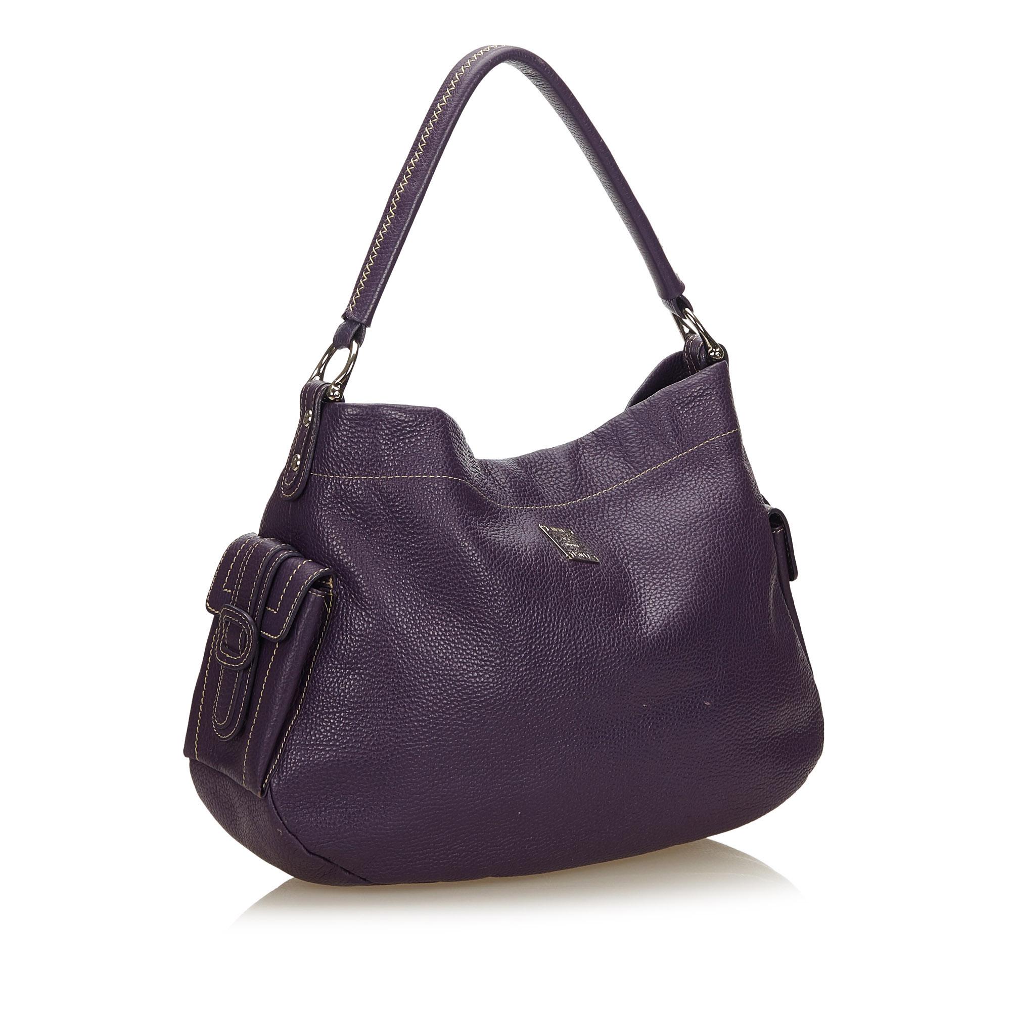 This handbag features a leather body, flat leather strap, open top, exterior flap pockets with magnetic closures, and interior zip and slip pocket. It carries as AB condition rating.

Inclusions: 
This item does not come with