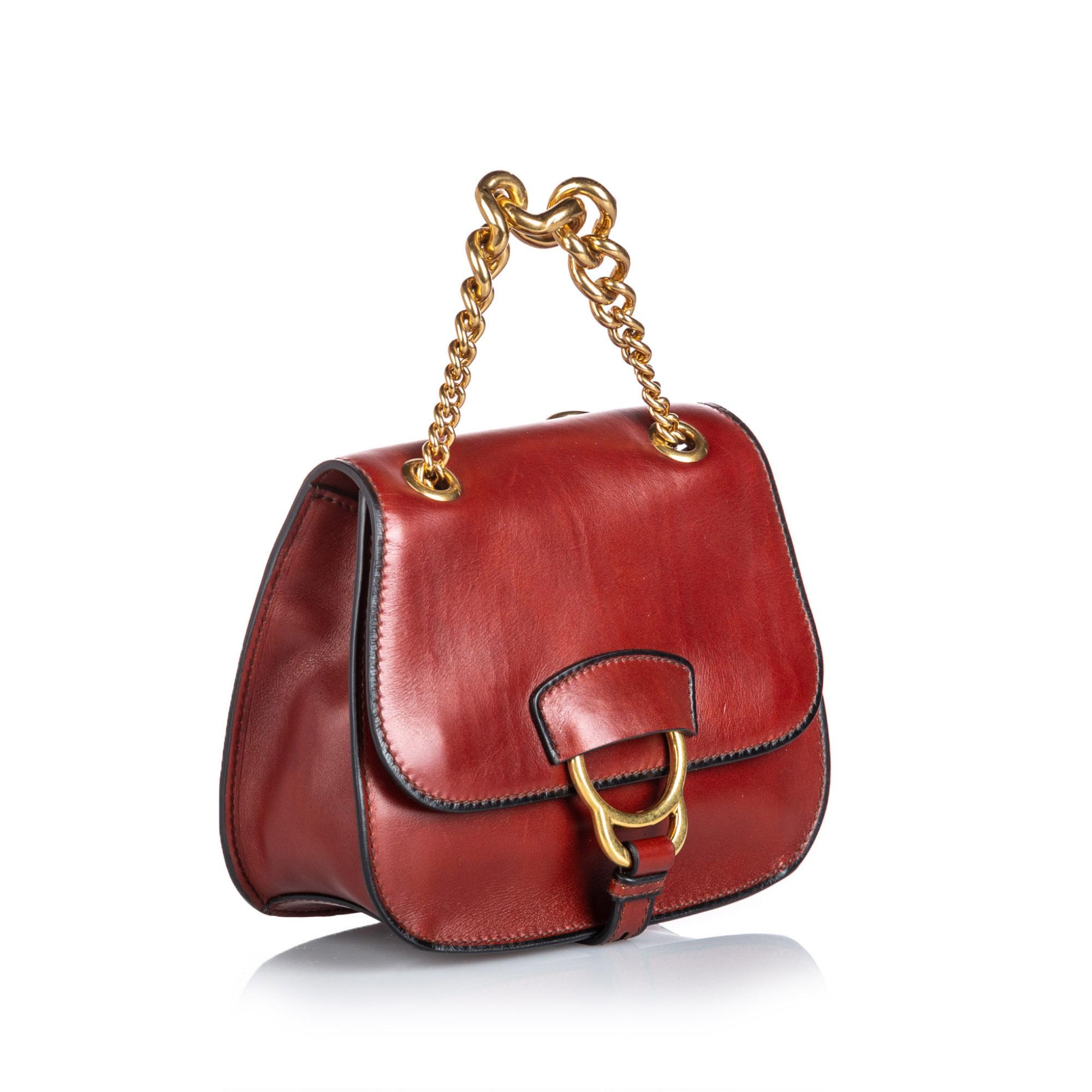 The Dahlia features a leather body, flat strap with gold toned chain, top flap with magnetic snap button closure, and an interior slip pocket. It carries as A condition rating.

Inclusions: 
Dust Bag
Authenticity Card
Dimensions:
Length: 18.00