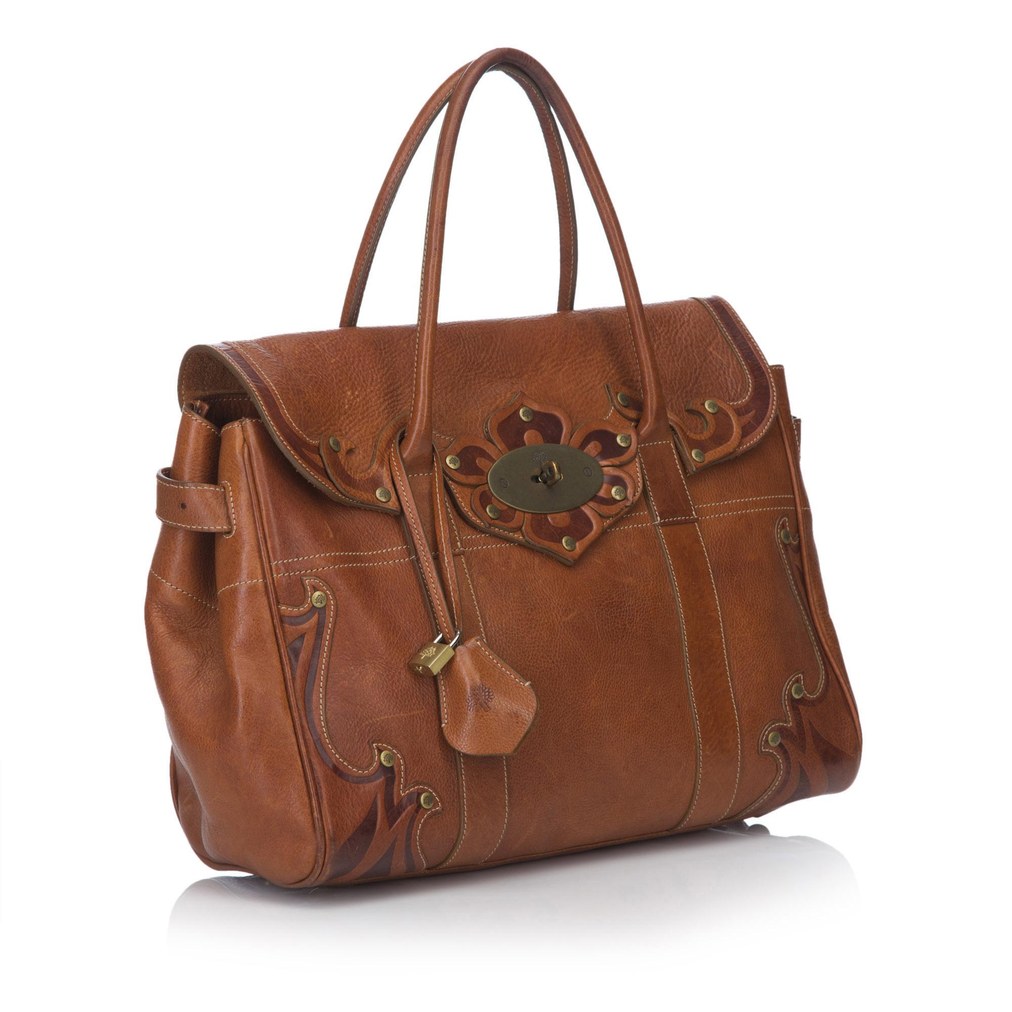 The Bayswater features a leather body, rolled handles, a front flap with a twist lock closure, adjustable belt details on the sides, metal feet, and an interior zip pocket. It carries as AB condition rating.

Inclusions: