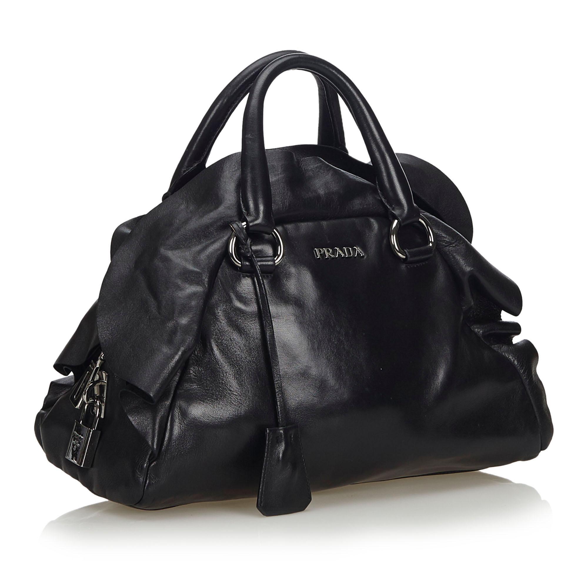 The Mordore handbag features a leather body, a ruffle detail, rolled leather handles, a clochette, a top zip closure, and interior zip and slip pockets. It carries as B+ condition rating.

Inclusions: 
This item does not come with