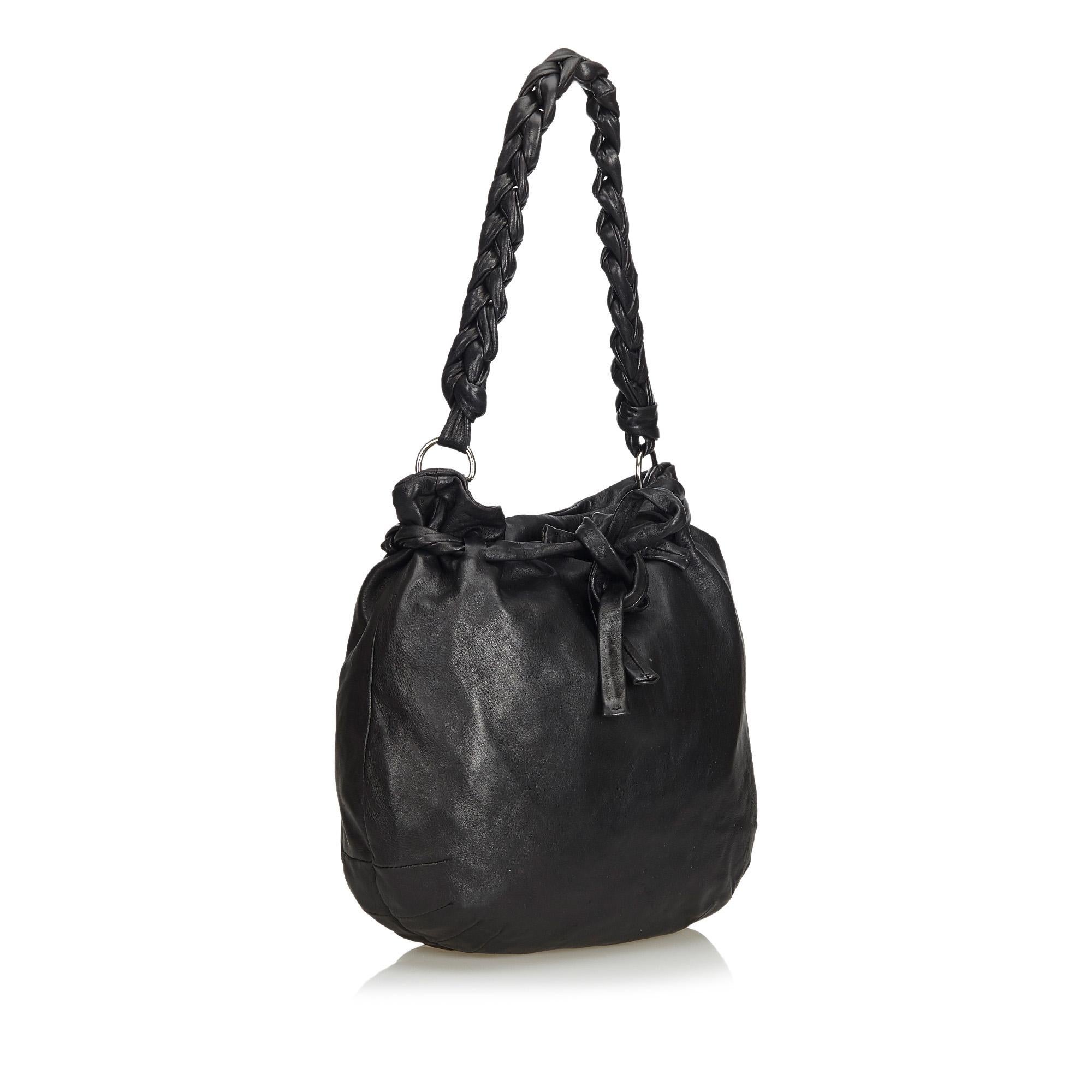 This shoulder bag features a leather body, a braided leather strap, open top with top magnetic closure, and interior slip and zip pockets. It carries as B+ condition rating.

Inclusions: 
This item does not come with inclusions.

Dimensions:
Length: