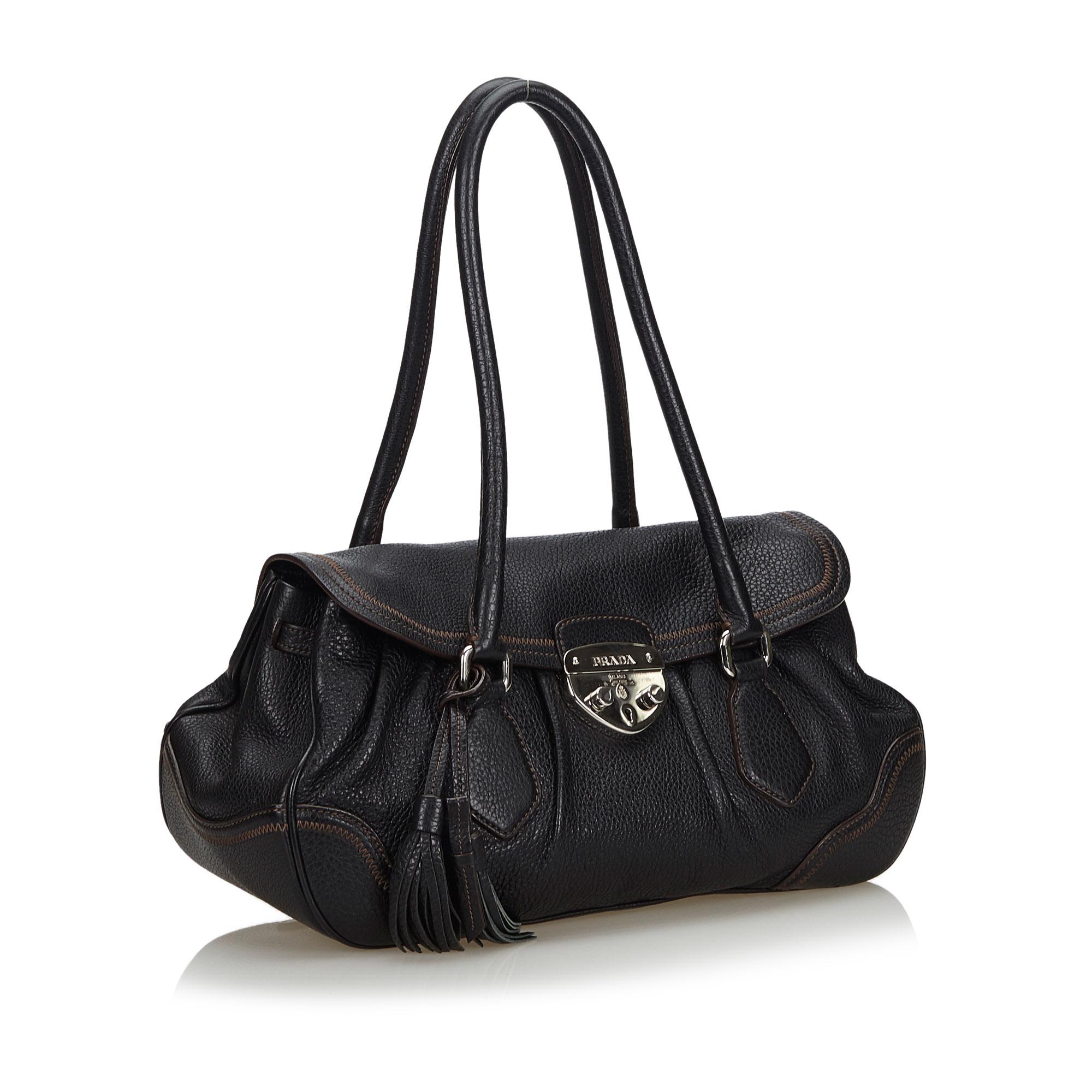 This shoulder bag features a leather body, rolled handles, top flap with push lock closure, and interior zip and slip pockets. It carries as B+ condition rating.

Inclusions: 
Dust Bag

Dimensions:
Length: 22.00 cm
Width: 38.00 cm
Depth: 18.50