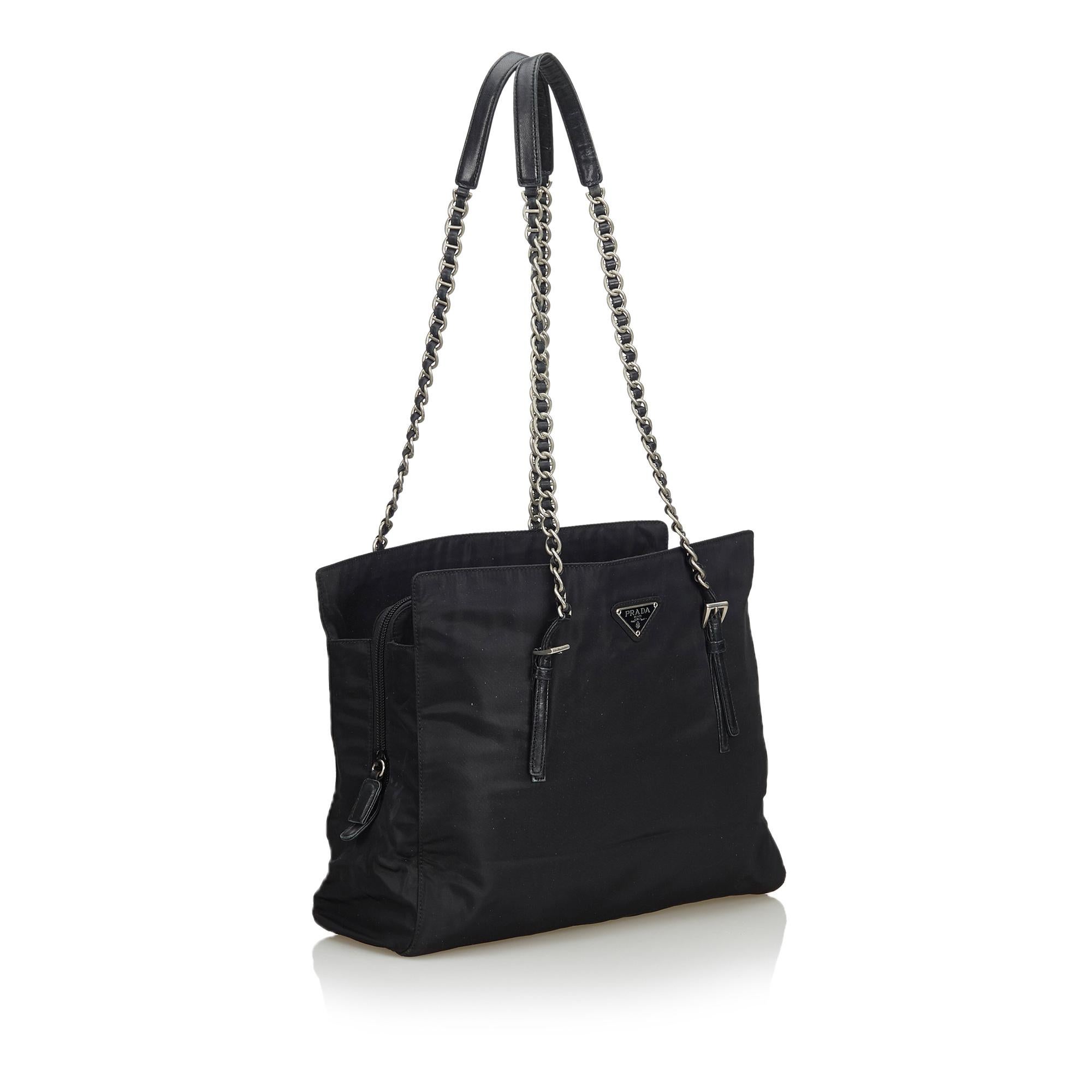 This shoulder bag features a nylon body, flat leather straps with silver-tone chain, a top zip closure, and an interior zip pocket. It carries as B+ condition rating.

Inclusions: 
This item does not come with inclusions.

Dimensions:
Length: 25.00