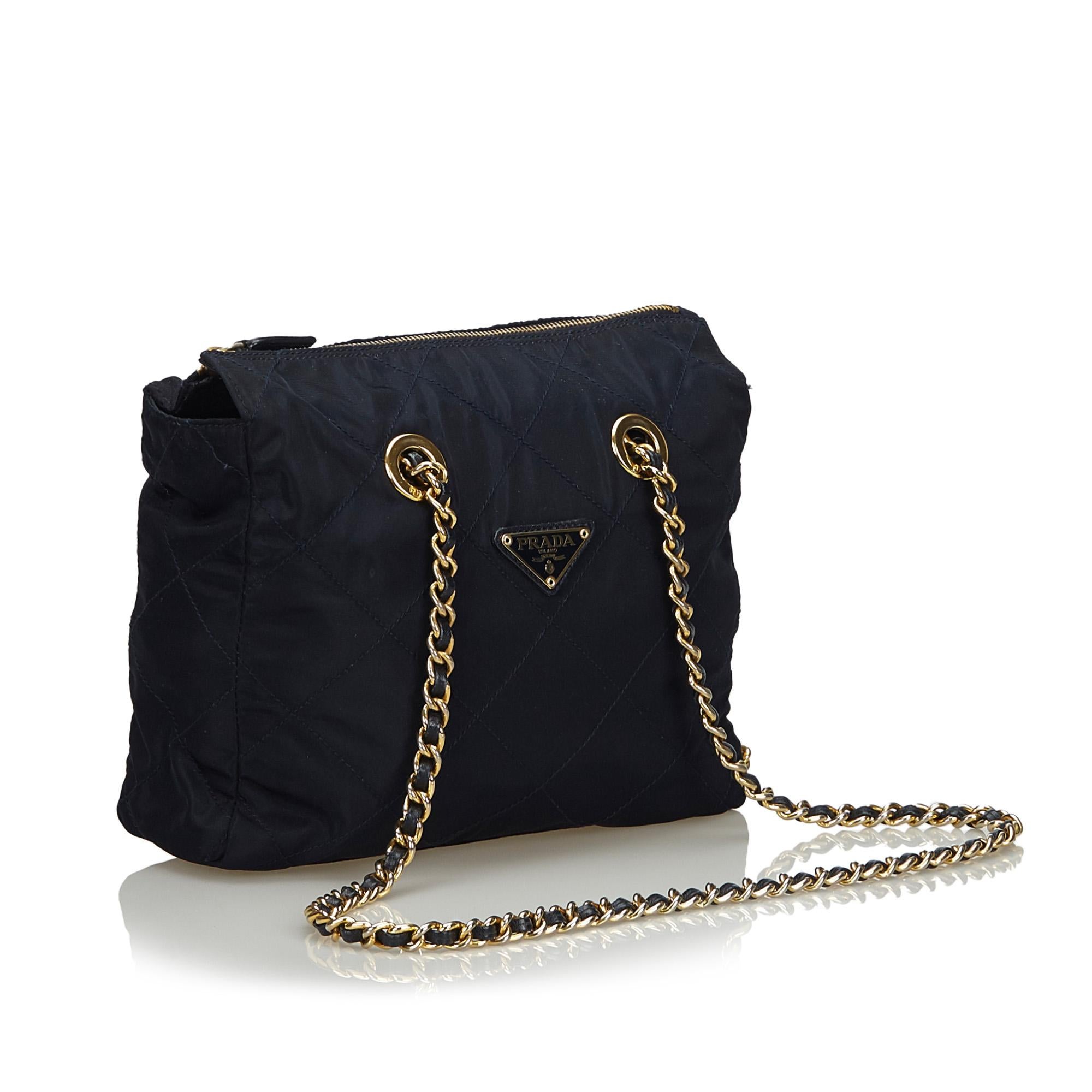 This shoulder bag feature a quilted nylon body, leather woven chain straps, top zip closure, and interior zip pocket. It carries as B+ condition rating.

Inclusions: 
This item does not come with inclusions.

Dimensions:
Length: 23.00 cm
Width: