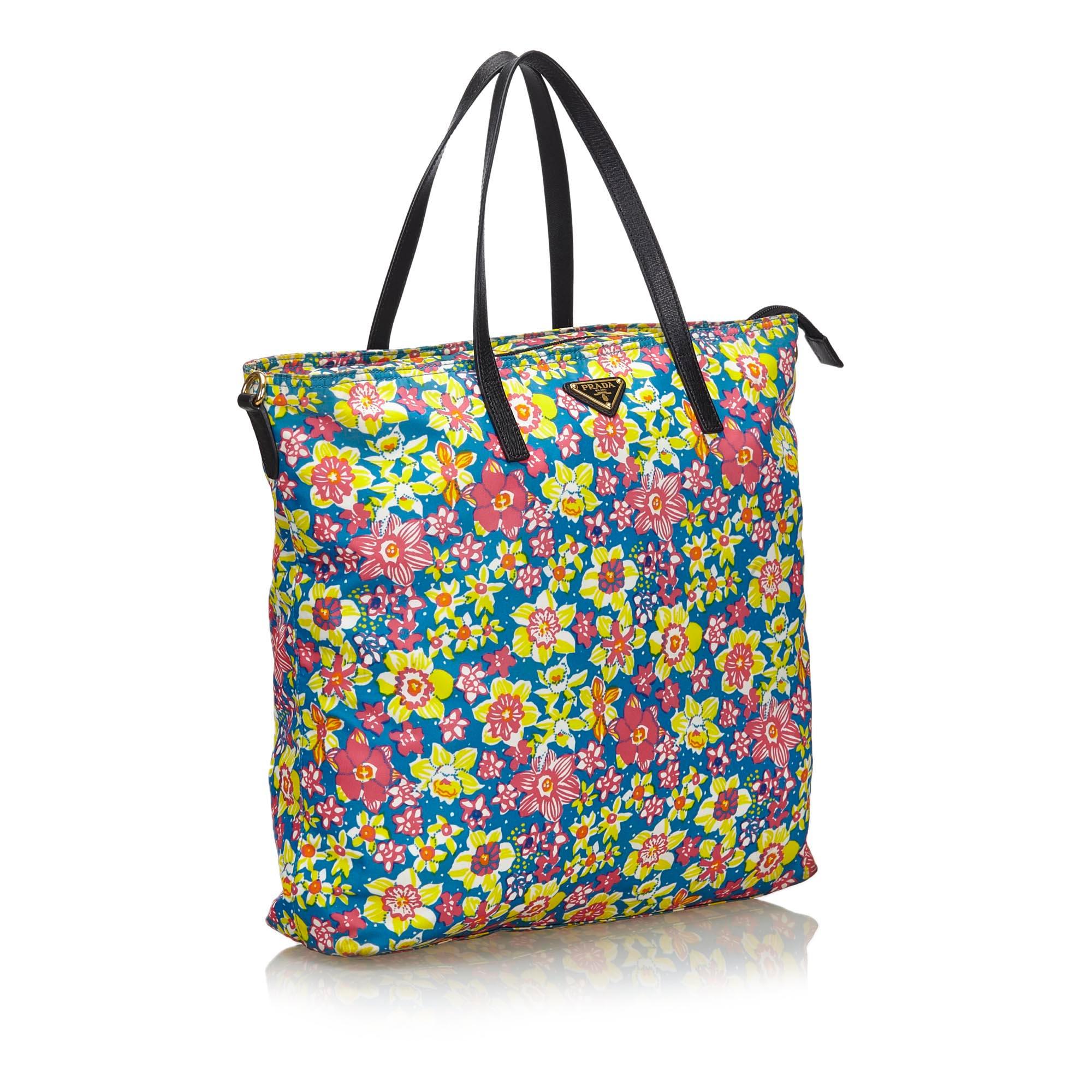 The Tessuto Stampato tote bag features a floral printed nylon body, flat leather straps, an open top, and interior zip pockets It carries as B+ condition rating.

Inclusions: 
This item does not come with inclusions.

Dimensions:
Length: 36.00