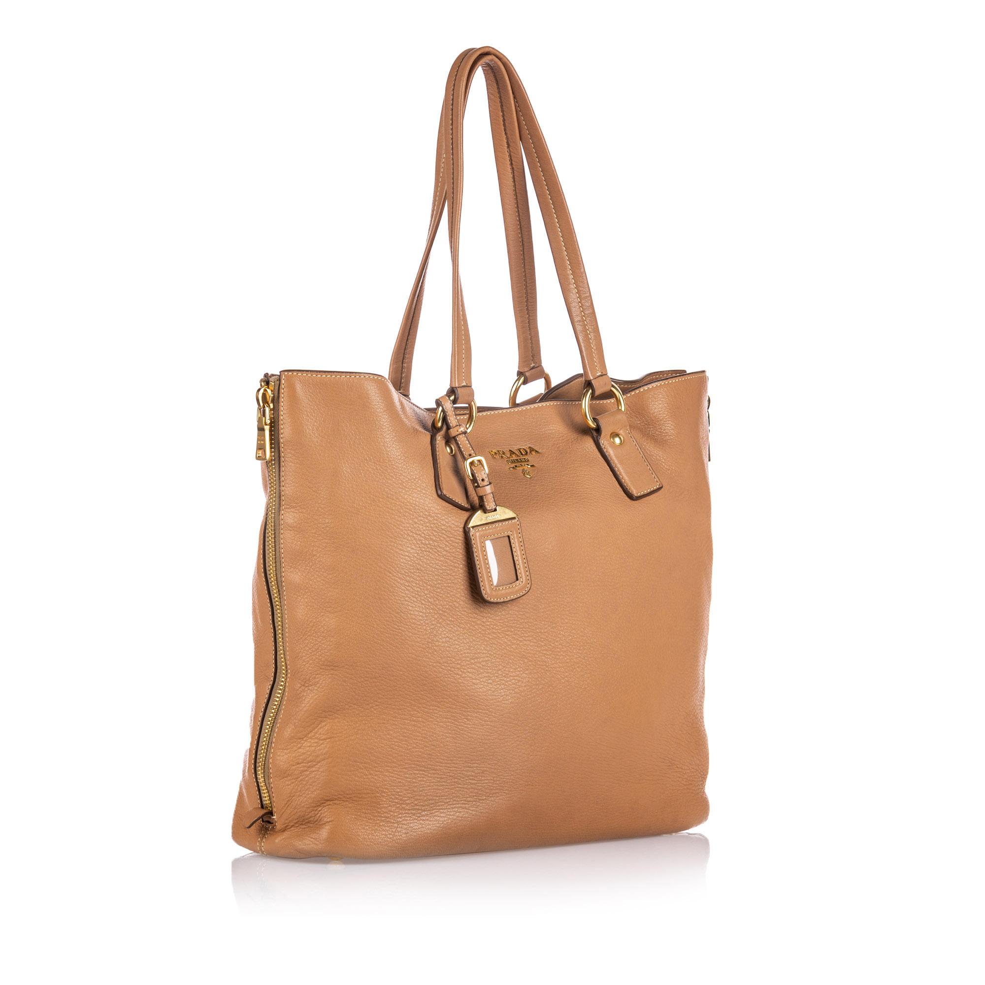 This tote bag features a leather body, flat leather handles, an open top with a magnetic snap button closure, and interior zip and slip pockets. It carries as AB condition rating.

Inclusions: 
This item does not come with