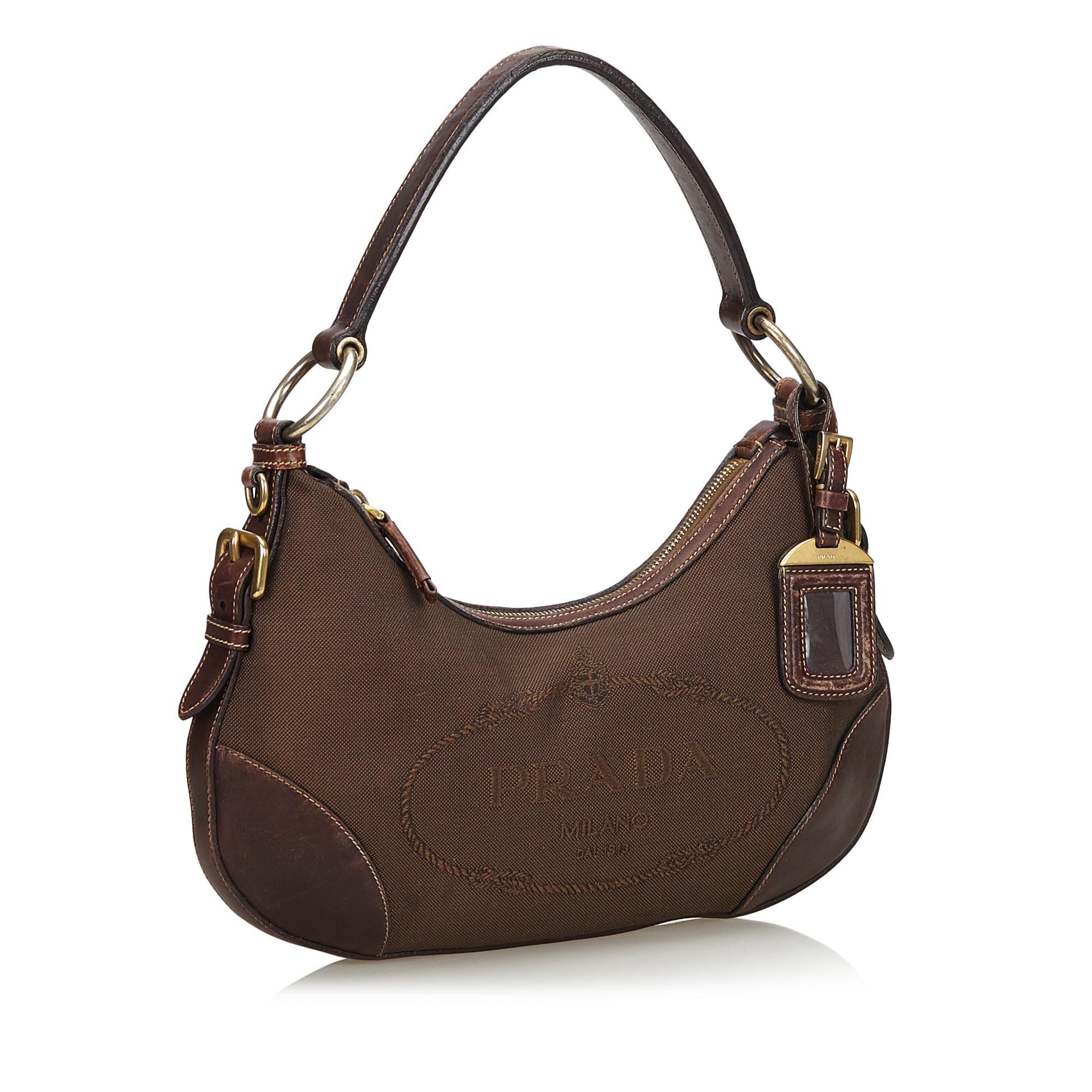This shoulder bag features a canvas body with leather trim, a flat leather strap, a top zip closure, and an interior zip pocket. It carries as B+ condition rating.

Inclusions: 
Authenticity Card

Dimensions:
Length: 20.00 cm
Width: 33.00 cm
Depth:
