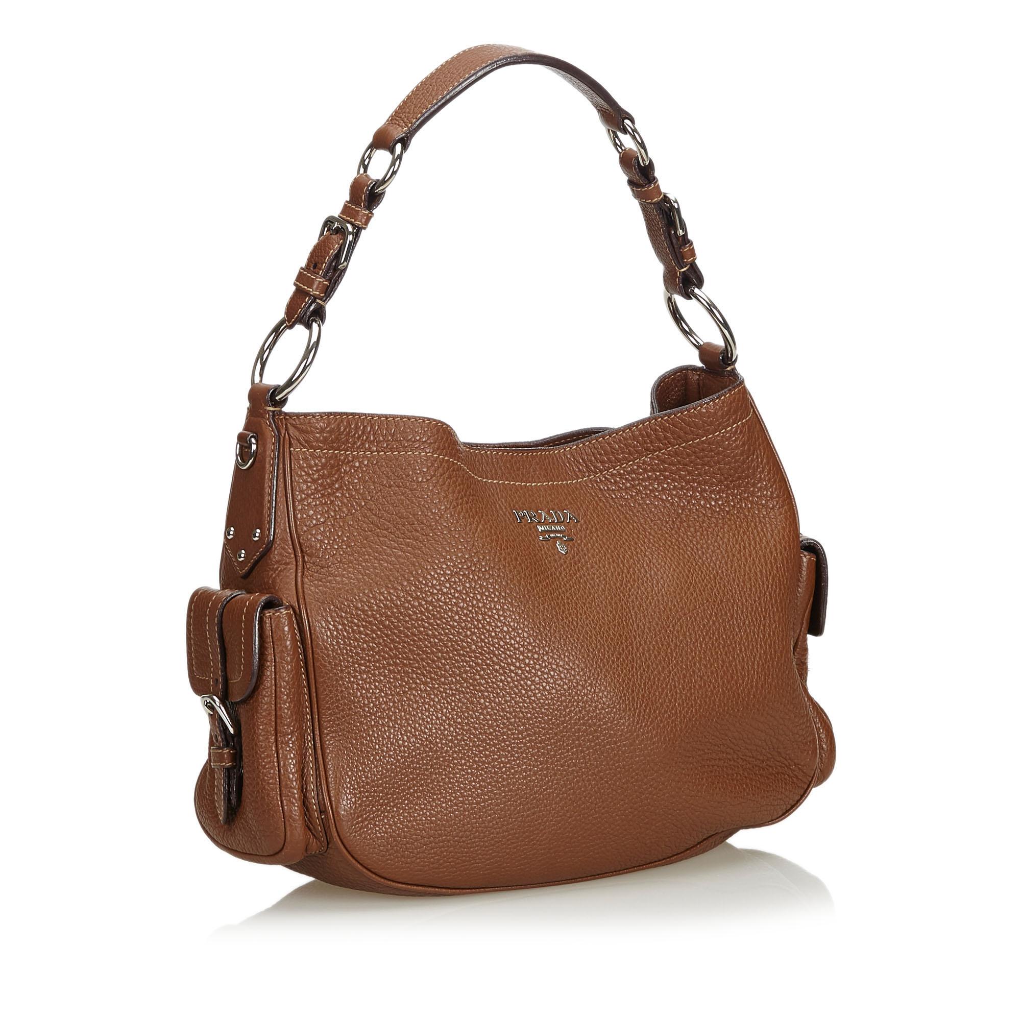 This shoulder bag features a leather body, exterior flap pockets, a flat leather strap, an open top with a magnetic snap button closure, and an interior zip pocket. It carries as B+ condition rating.

Inclusions: 
This item does not come with