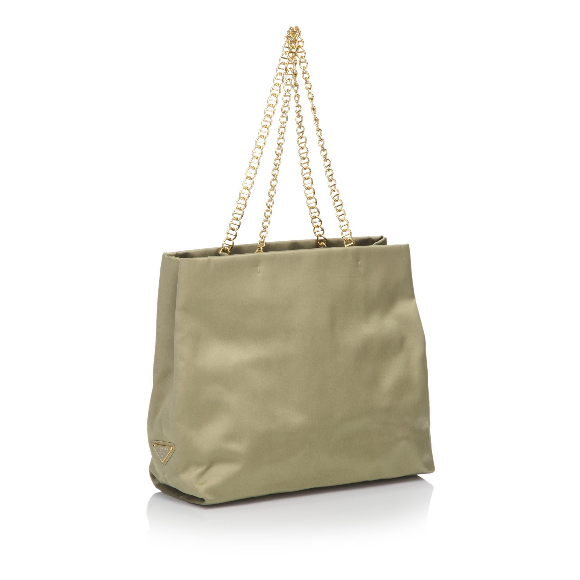 This tote bag features a satin body, gold-tone chain handles, open top and interior zip pocket. It carries as B condition rating.

Inclusions: 
Dust Bag
Dimensions:
Length: 34.00 cm
Width: 28.00 cm
Depth: 11.00 cm
Hand Drop: 23.00 cm
Shoulder Drop: