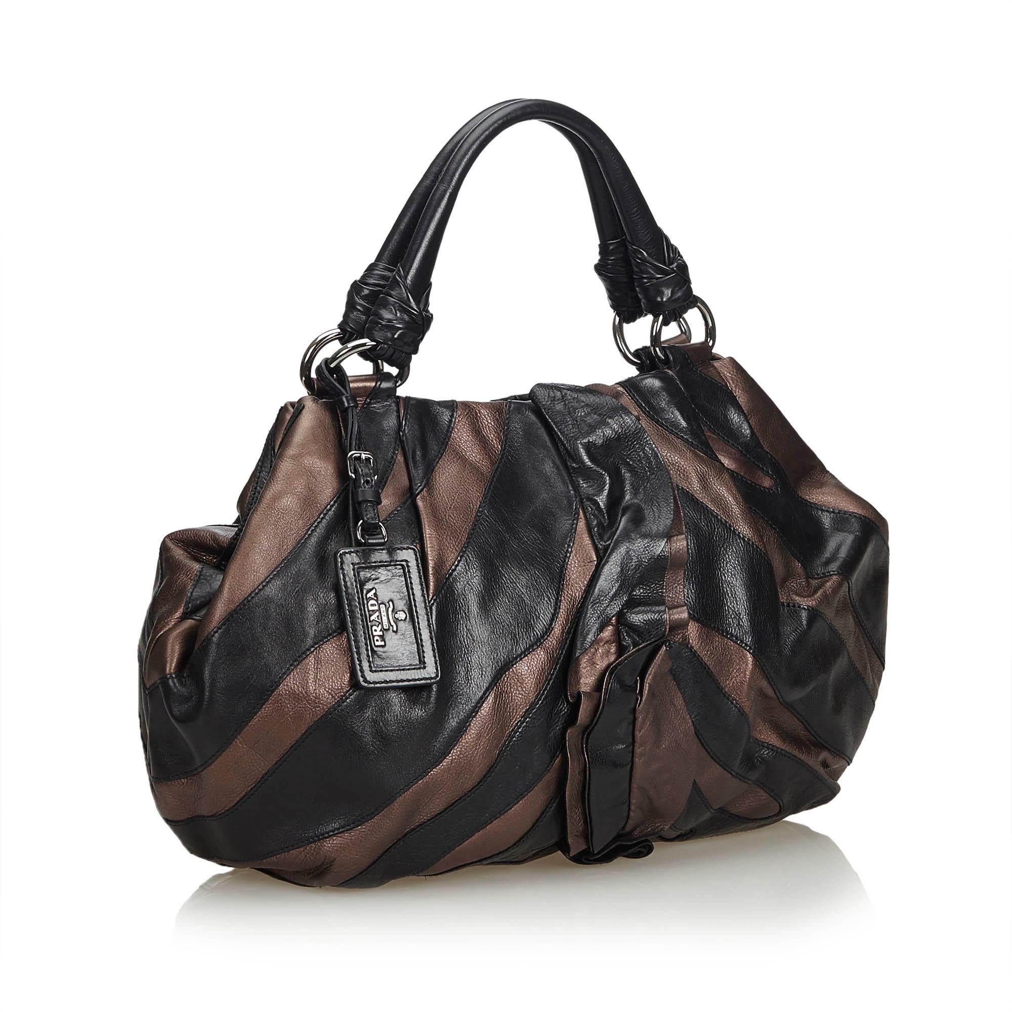 This Mordore tote bag features a ruffled leather body, rolled leather handles, an open top with a magnetic closure, and interior zip and slip pockets. It carries as AB condition rating.

Inclusions: 
Authenticity Card
Dimensions:
Length: 32.00