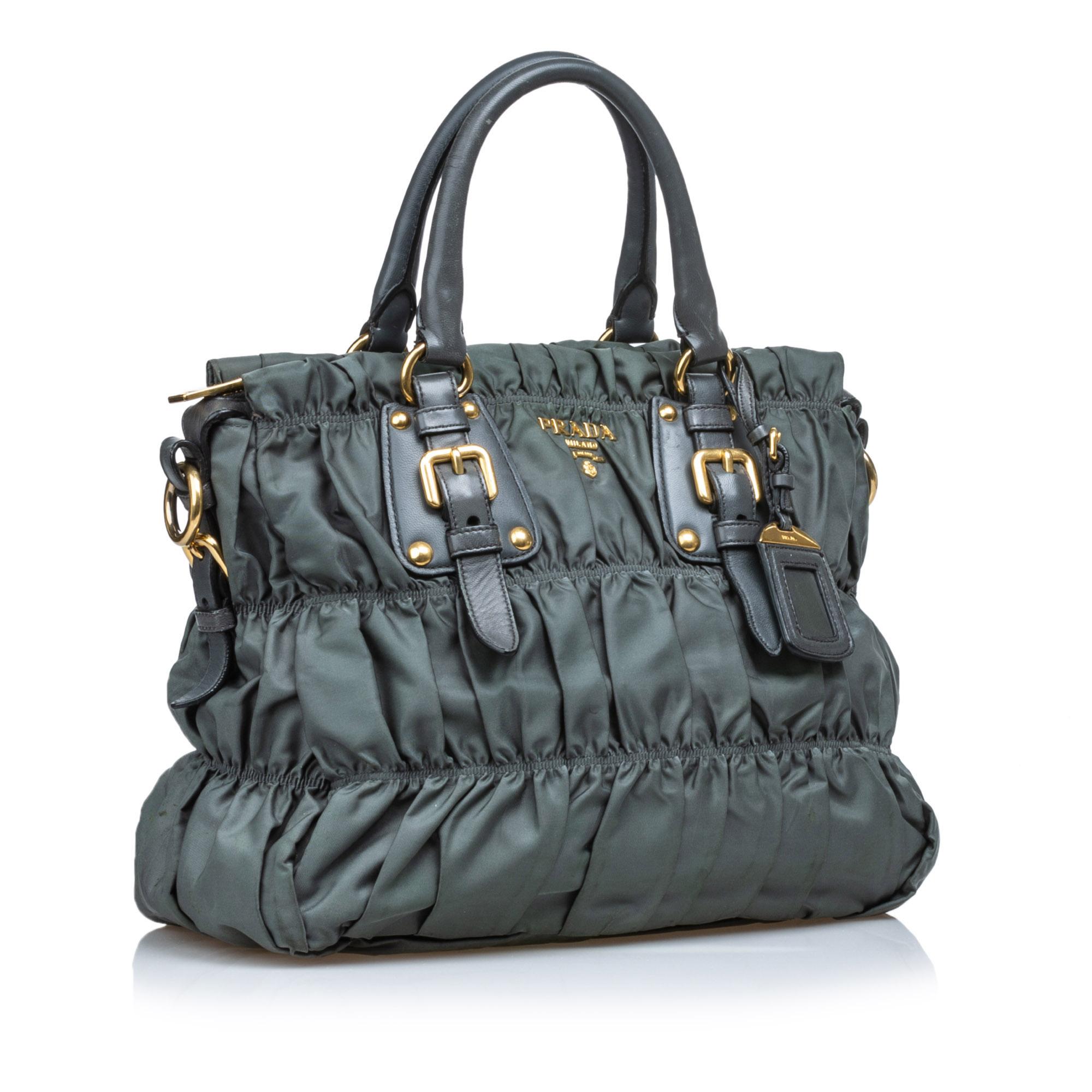 This handbag features a gathered nylon body, rolled leather handles, a top zip closure, and interior zip and slip pockets. It carries as B+ condition rating.

Inclusions: 
Dust Bag

Dimensions:
Length: 40.00 cm
Width: 32.00 cm
Depth: 5.00 cm
Hand