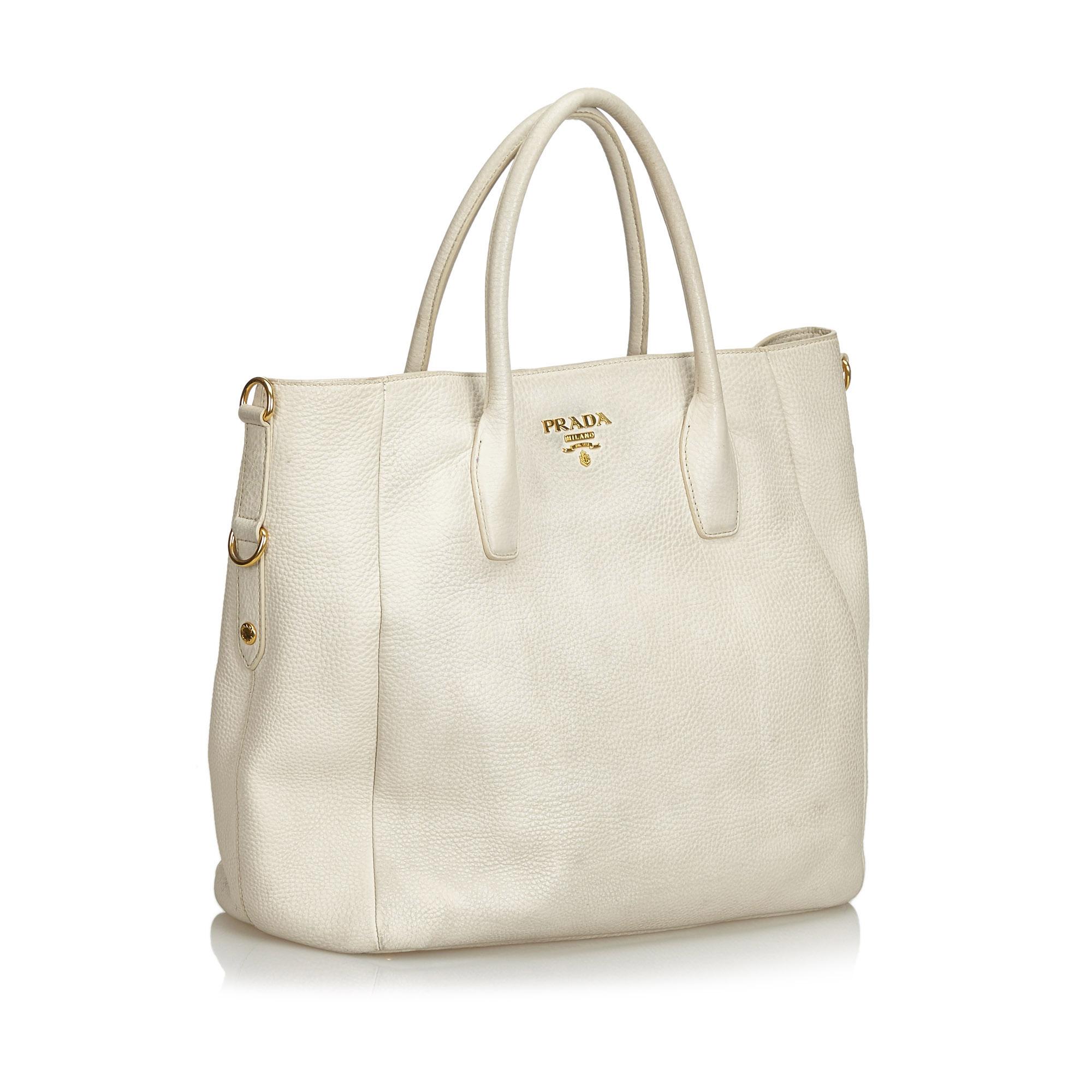This handbag features a leather body, rolled handles, open top with snap button closure, and interior zip and slip pockets. It carries as B condition rating.

Inclusions: 
This item does not come with inclusions.

Dimensions:
Length: 33.00 cm
Width: