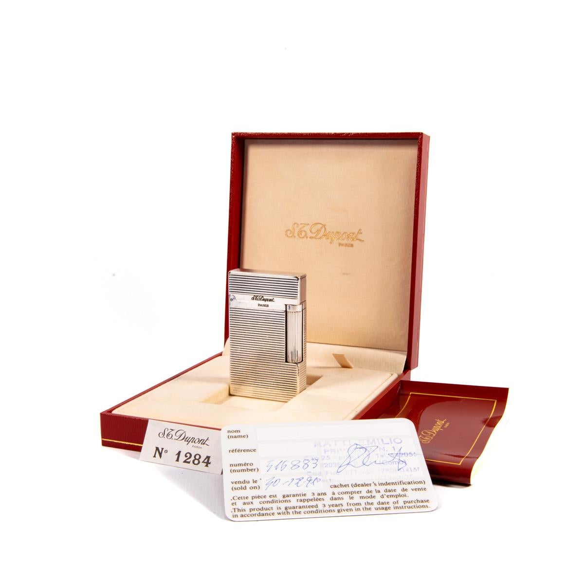 Vintage Authentic Silver plated Ligne 2 ST Dupont Lighter Complete Box & Papers

The iconic S.T. Dupont name is known for quality, well-made cigarette lighters and other luxury implements. The company’s origin can be traced to Simon Tissot-Dupont