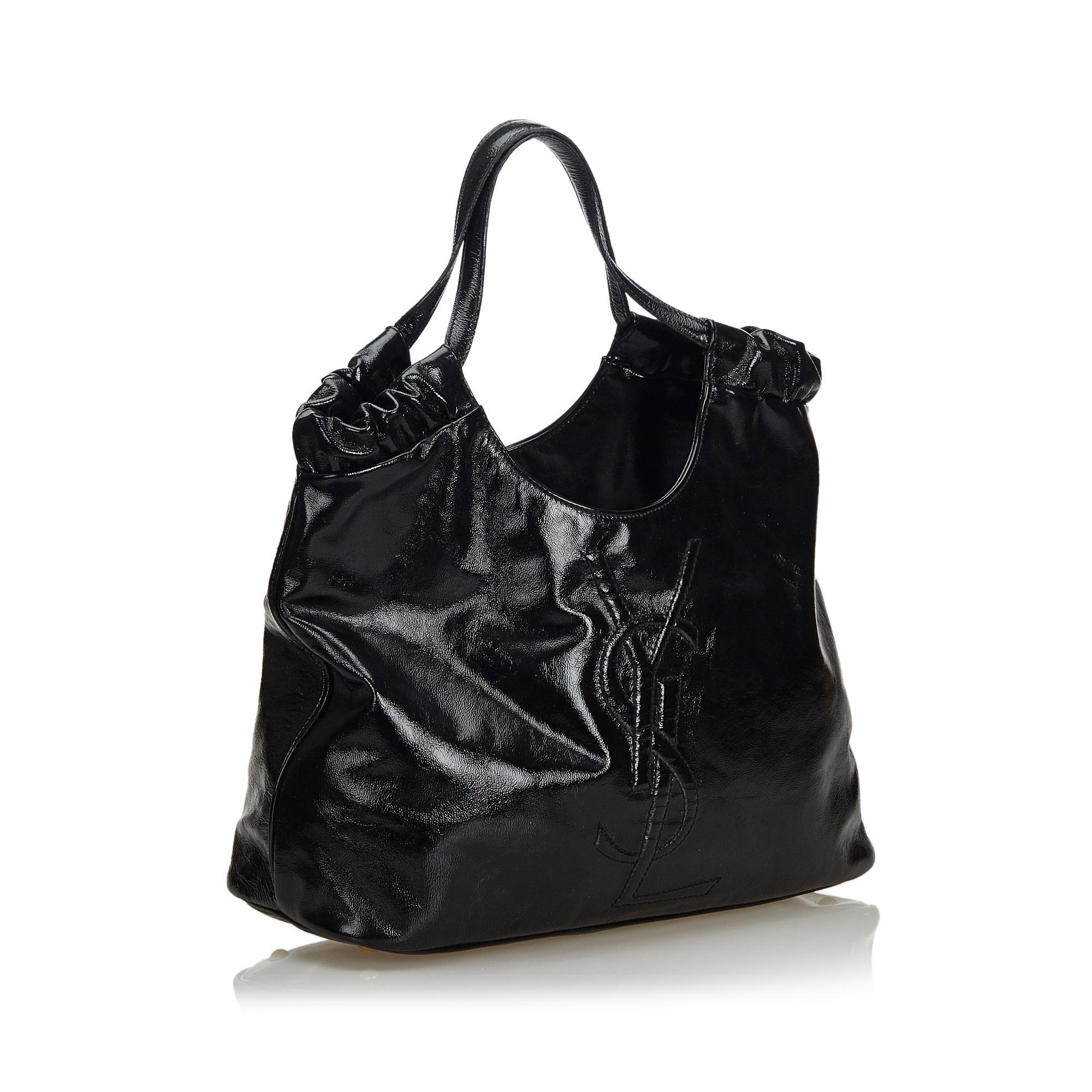 The Belle de Jour tote bag features a patent leather body, flat leather handles, an open top, and interior zip and slip pockets. It carries as AB condition rating.

Inclusions: 
This item does not come with inclusions.

Dimensions:
Length: 23.00