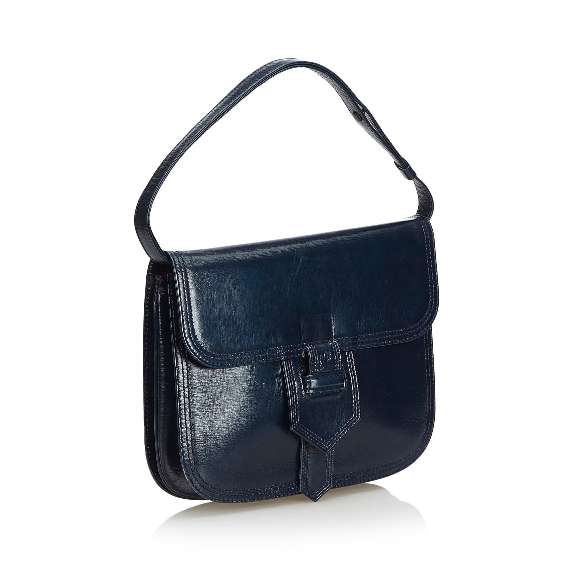This handbag features a leather body, a flat leather handle, a front flap with a strap closure, and interior zip and slip pocket. It carries as B condition rating.

Inclusions: 
Dust Bag

Dimensions:
Length: 21.00 cm
Width: 24.50 cm
Depth: 2.00