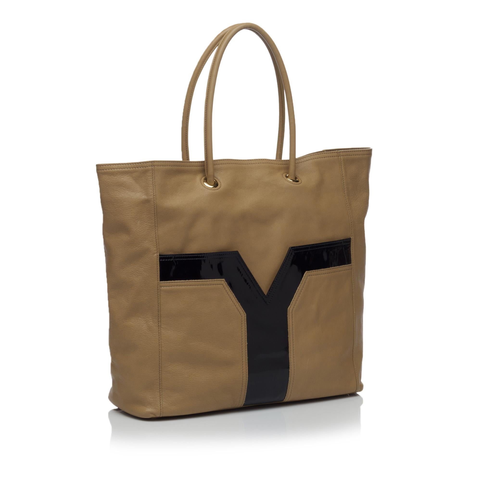 The Lucky Chyc tote features a leather body with a patent leather detail, an open top, and interior flap pockets. It carries as AB condition rating.

Inclusions: 
Dust Bag
Authenticity Card

Dimensions:
Length: 34.00 cm
Width: 32.00 cm
Depth: 11.00