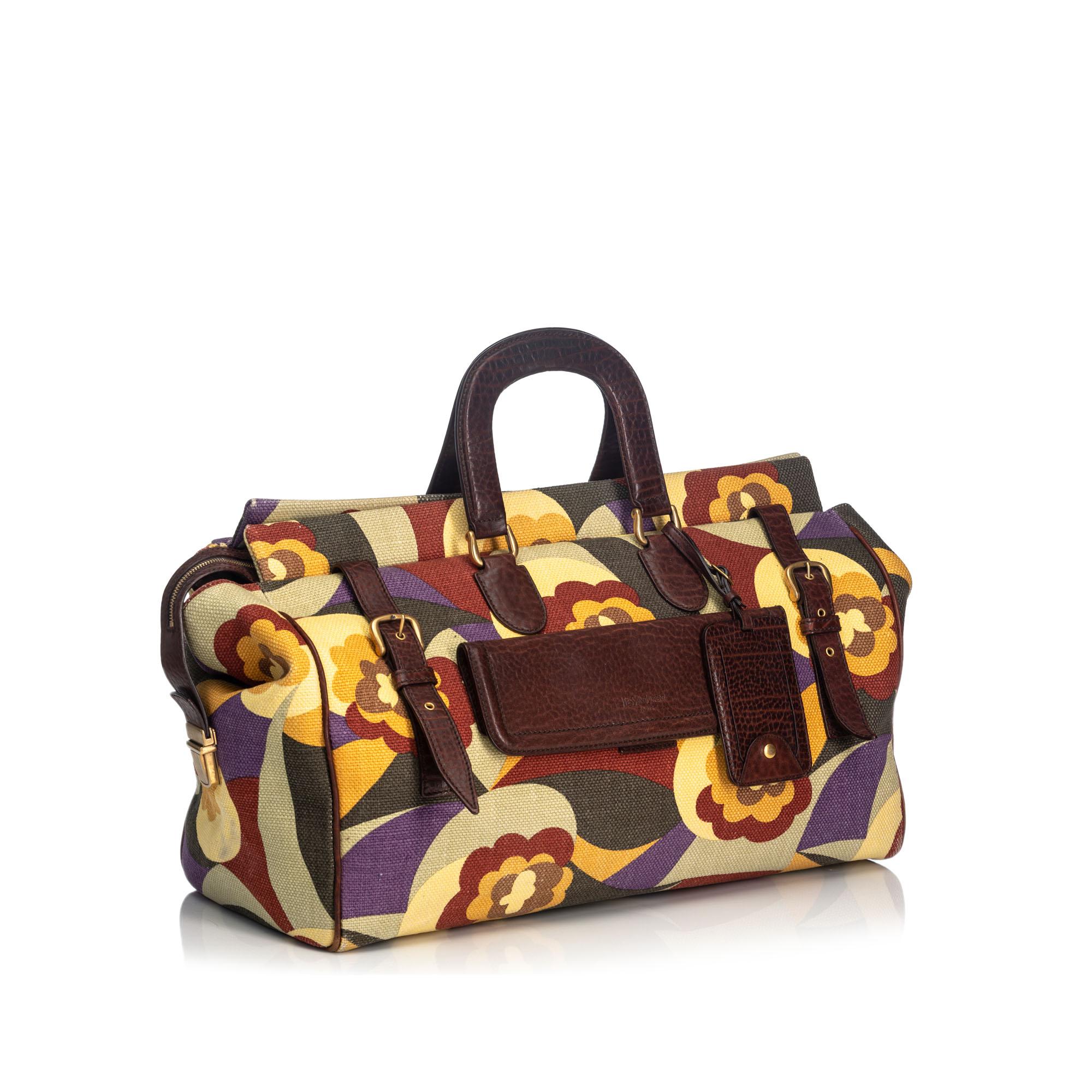 This travel bag features a canvas body, a front exterior flap pocket, a leather top handle, a top zip closure, and an interior zip pocket. It carries as B+ condition rating.

Inclusions: 
This item does not come with inclusions.

Dimensions:
Length: