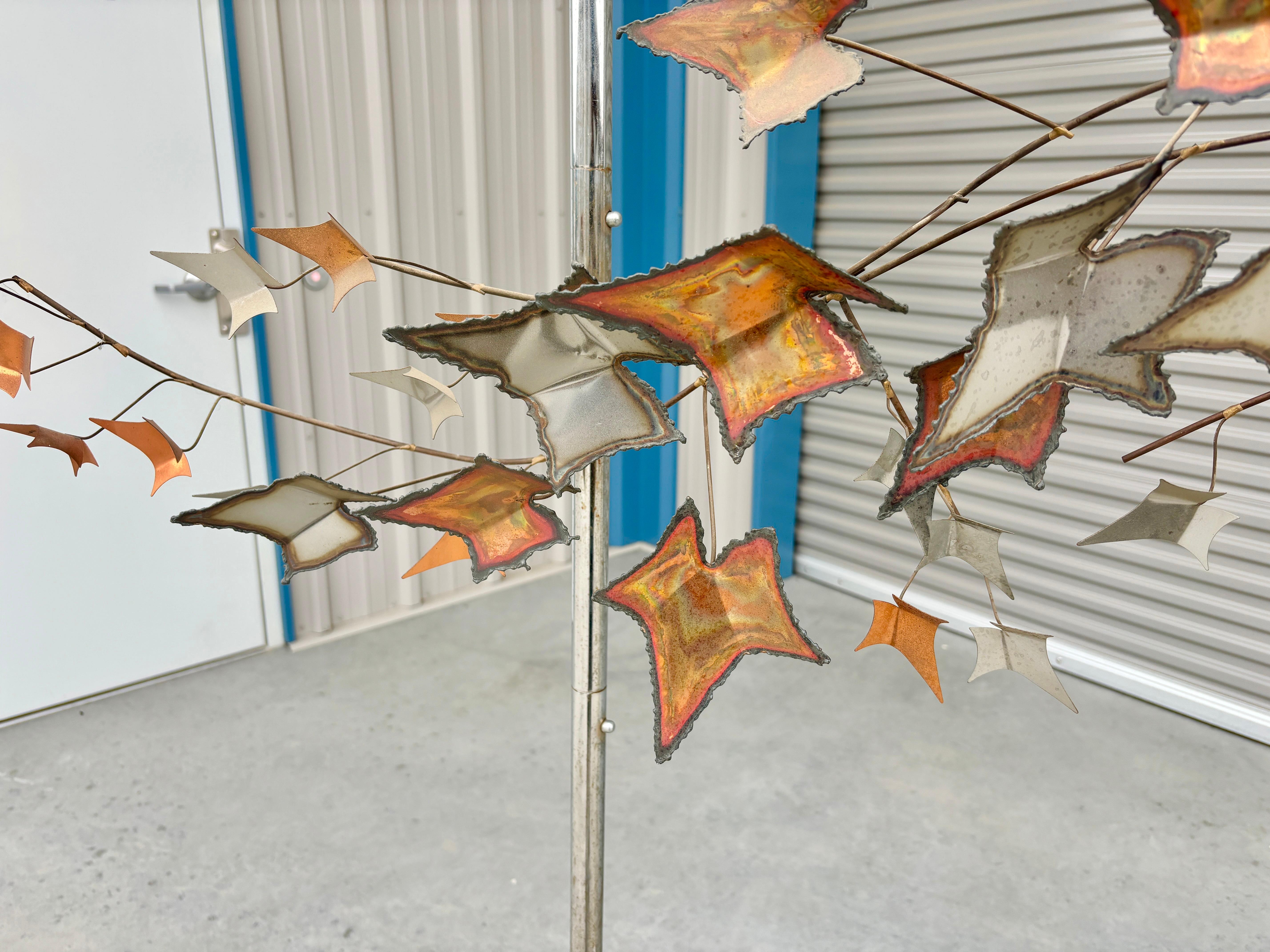 This exquisite mid-century Autumn Leaves Wall Sculpture, designed and crafted by the renowned artist Curtis Jere in the 1970s, is a stunning piece that captures the essence of fall. The sculpture features an intricate arrangement of leaves in rich,