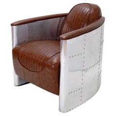 Sillón Vintage Aviator de aluminio remachado y cuero coñac