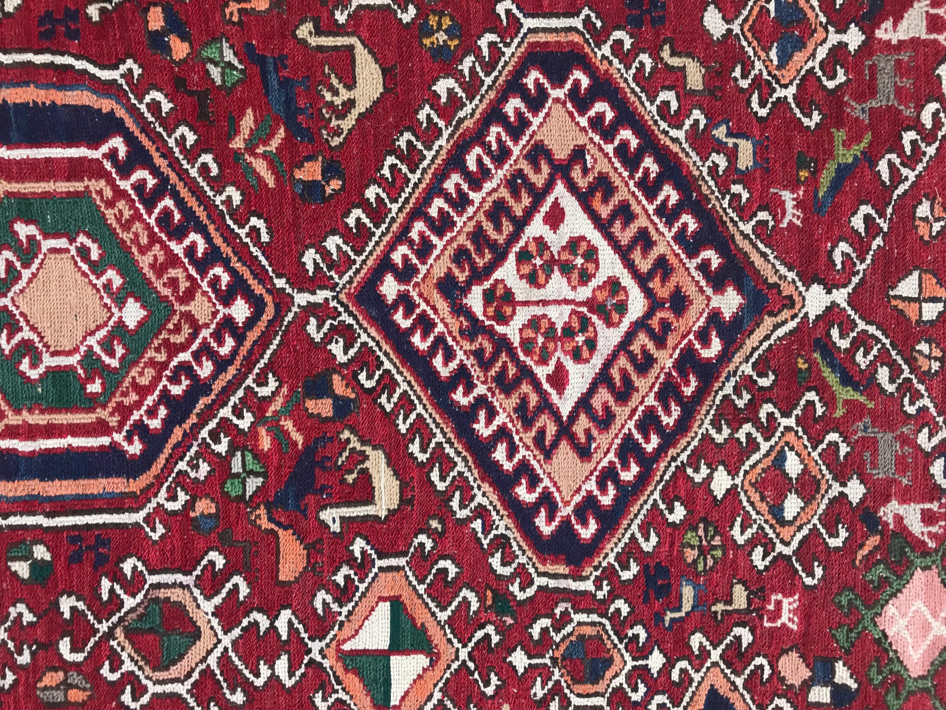 Discover the elegance of our late 20th-century Azerbaijan Shahsavand flat rug. Immerse yourself in its captivating tribal geometrical Caucasian design, featuring stylized animals and vibrant colors – a masterpiece handwoven and embroidered with wool